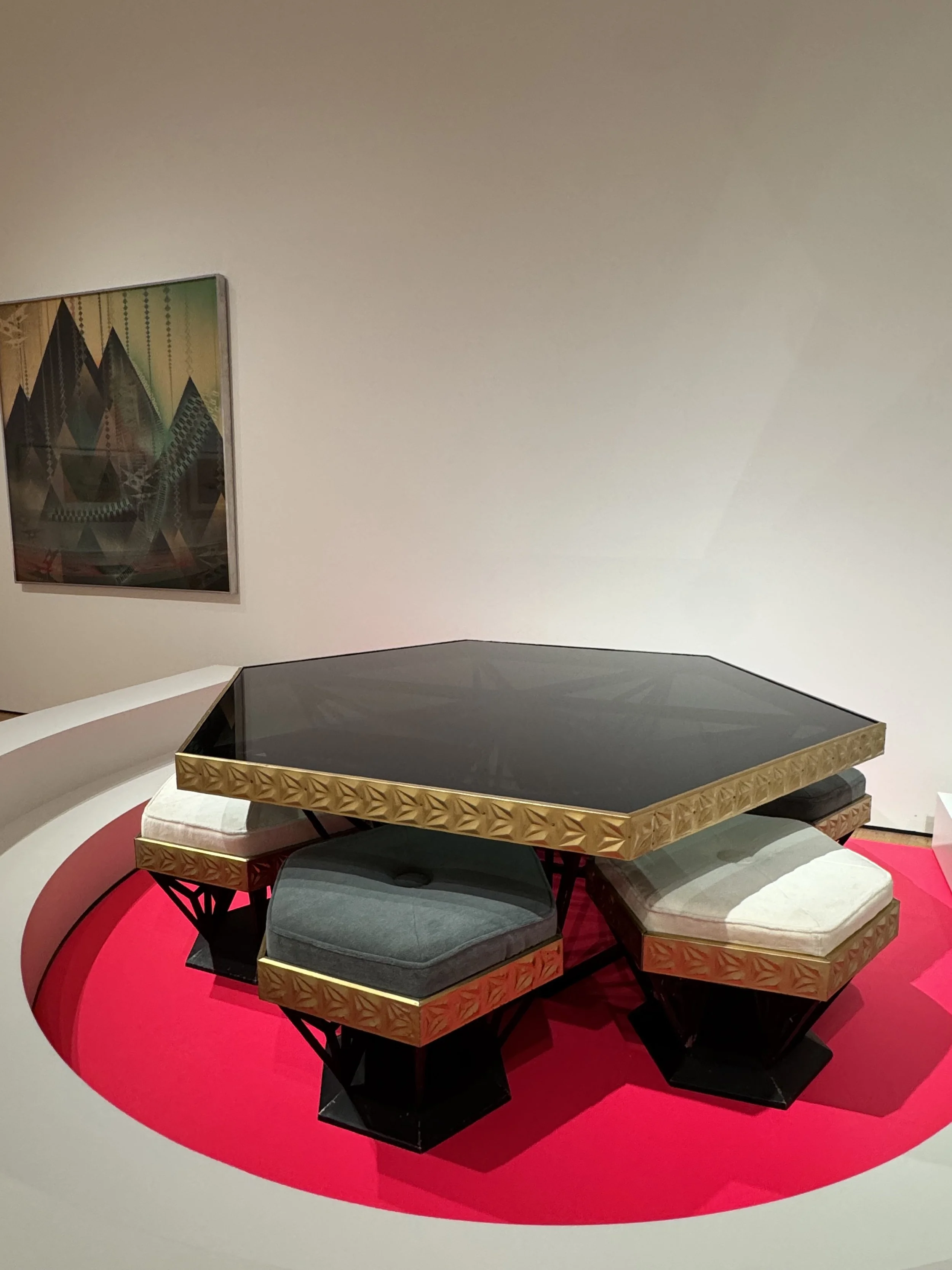 Image of a small pentagon shaped table with 5 stools