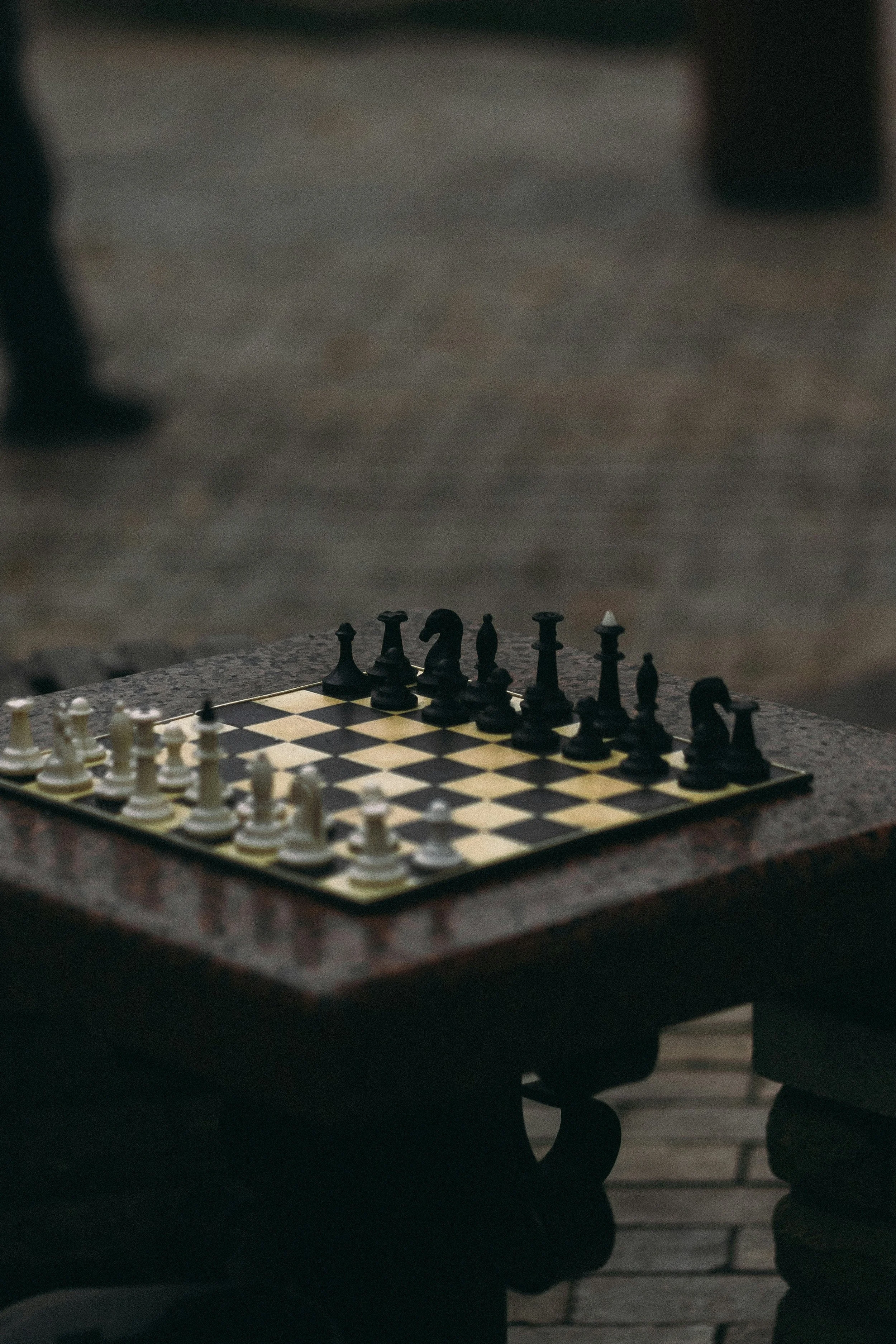 Chess board set on a stone table, representing strategic thinking, foresight, and considered decision-making