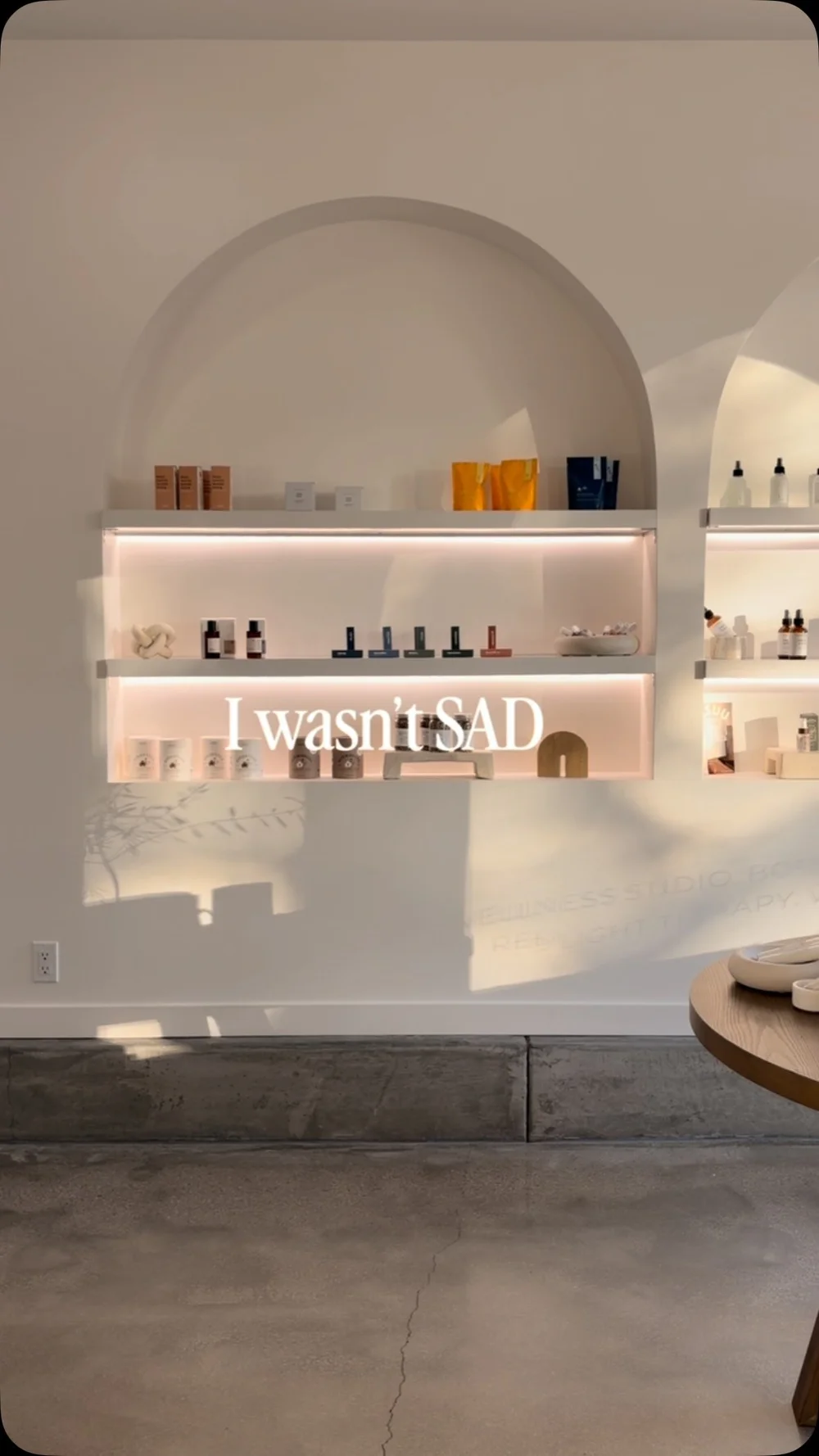 Product shelves set into a white arched alcove in the studio's front room