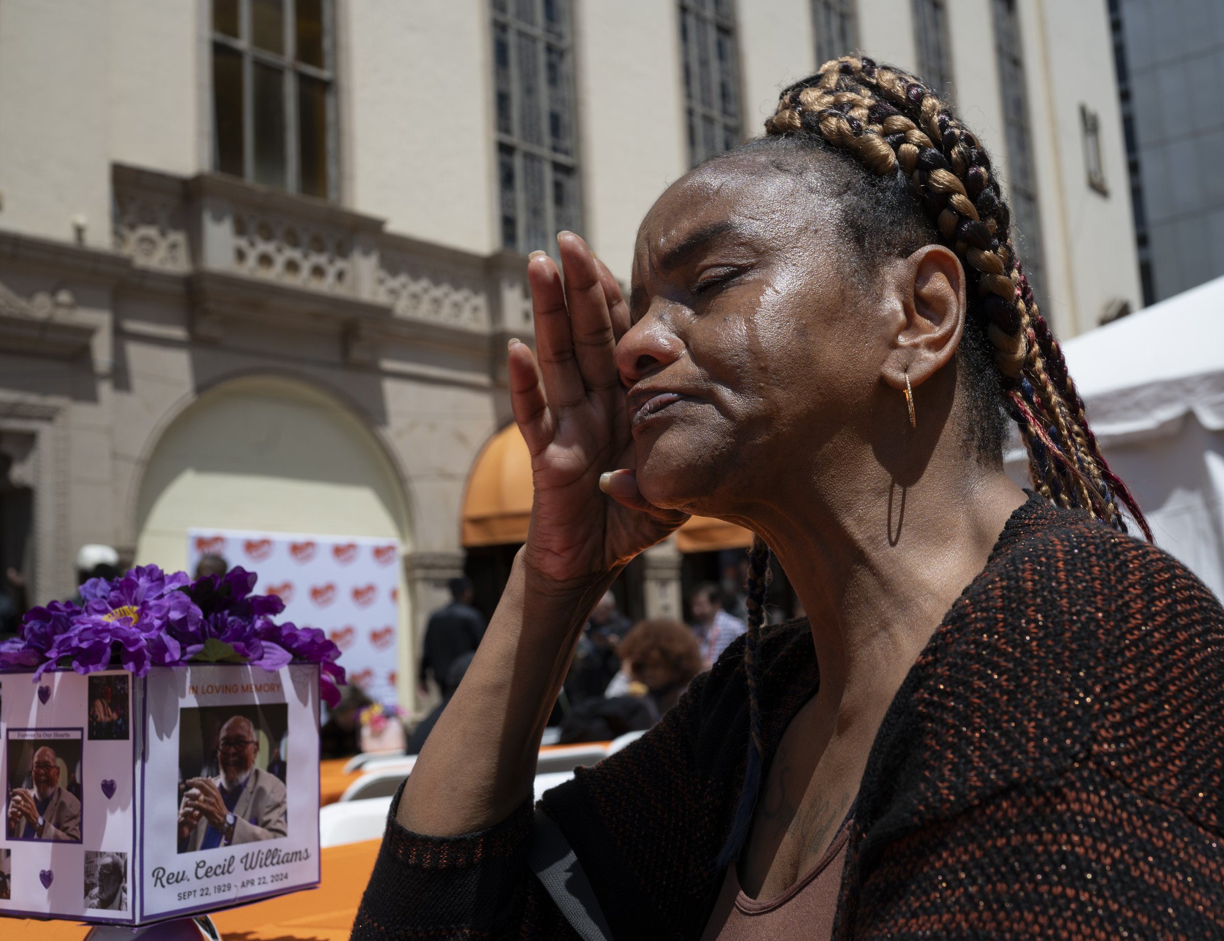 Memorial for Rev. Cecil Williams, Ellis St. San Francisco, 2024. Rhonda (last name withheld) sheds a tear recounting the time Rev Williams helped in her time of need.