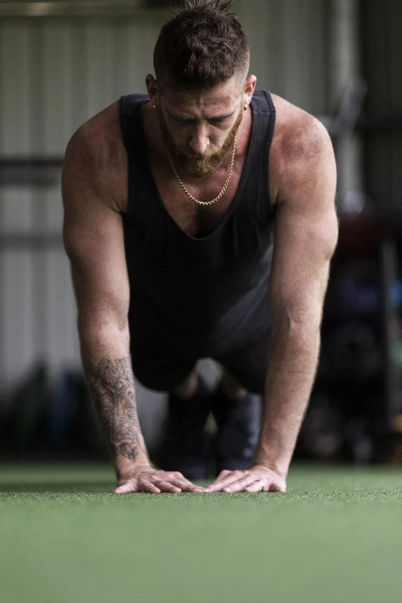 Man in a gym with kettlebells on shelves