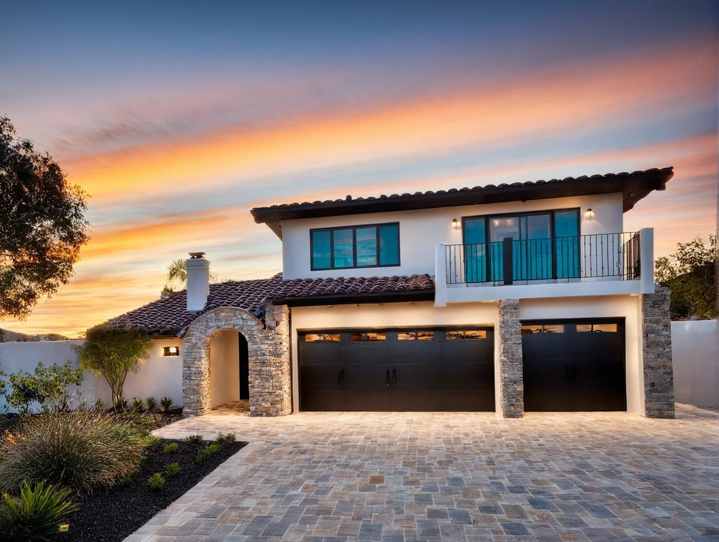 Exterior overhaul! Minor enhancements to a client's 1970's home, we transformed the era with pavers in the driveway, elegant black accents, and a charming balcony over the master bedroom, creating an updated and welcoming curb appeal.