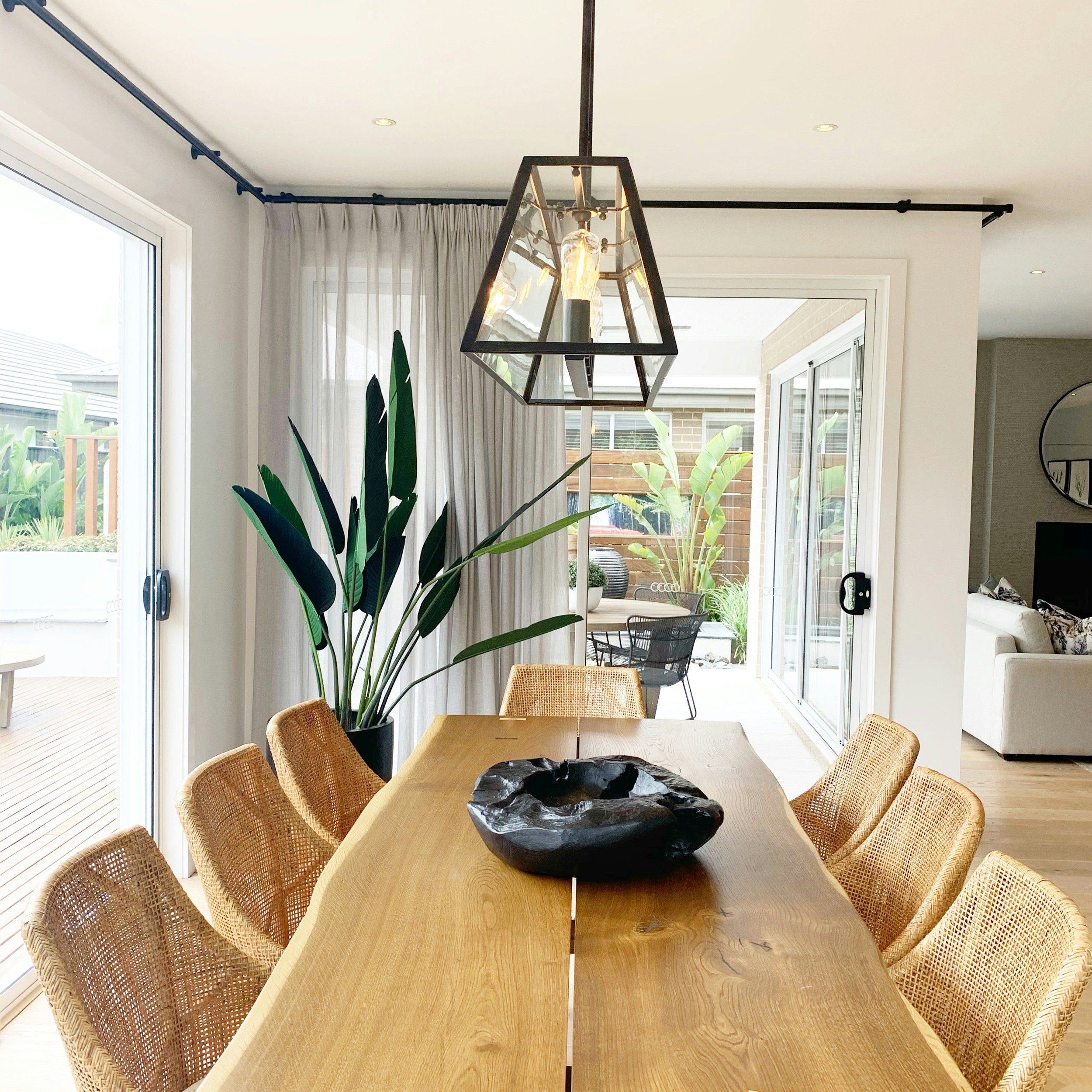 Earthy home renovation showcasing a custom live edge dining table and indoor/outdoor living incorporated seamlessly into the design.