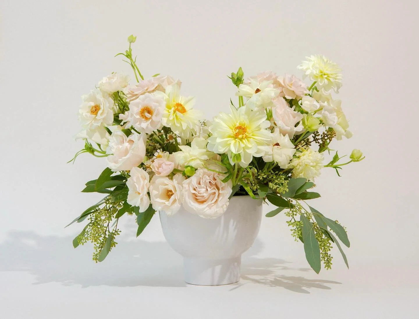 Introducing Ivory Haze 🌸

This arrangement features a delicate mix of seasonal blooms in ivory and subtle blush tones. Paired with lush greenery and designed in a modern vase; this arrangement is ideal for a coffee table, entryway, or as a thoughtfu