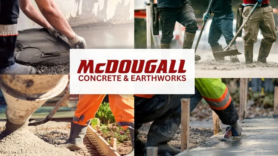 A yellow and red concrete pump hopper with pipes and a frame, placed on dirt in an industrial yard.