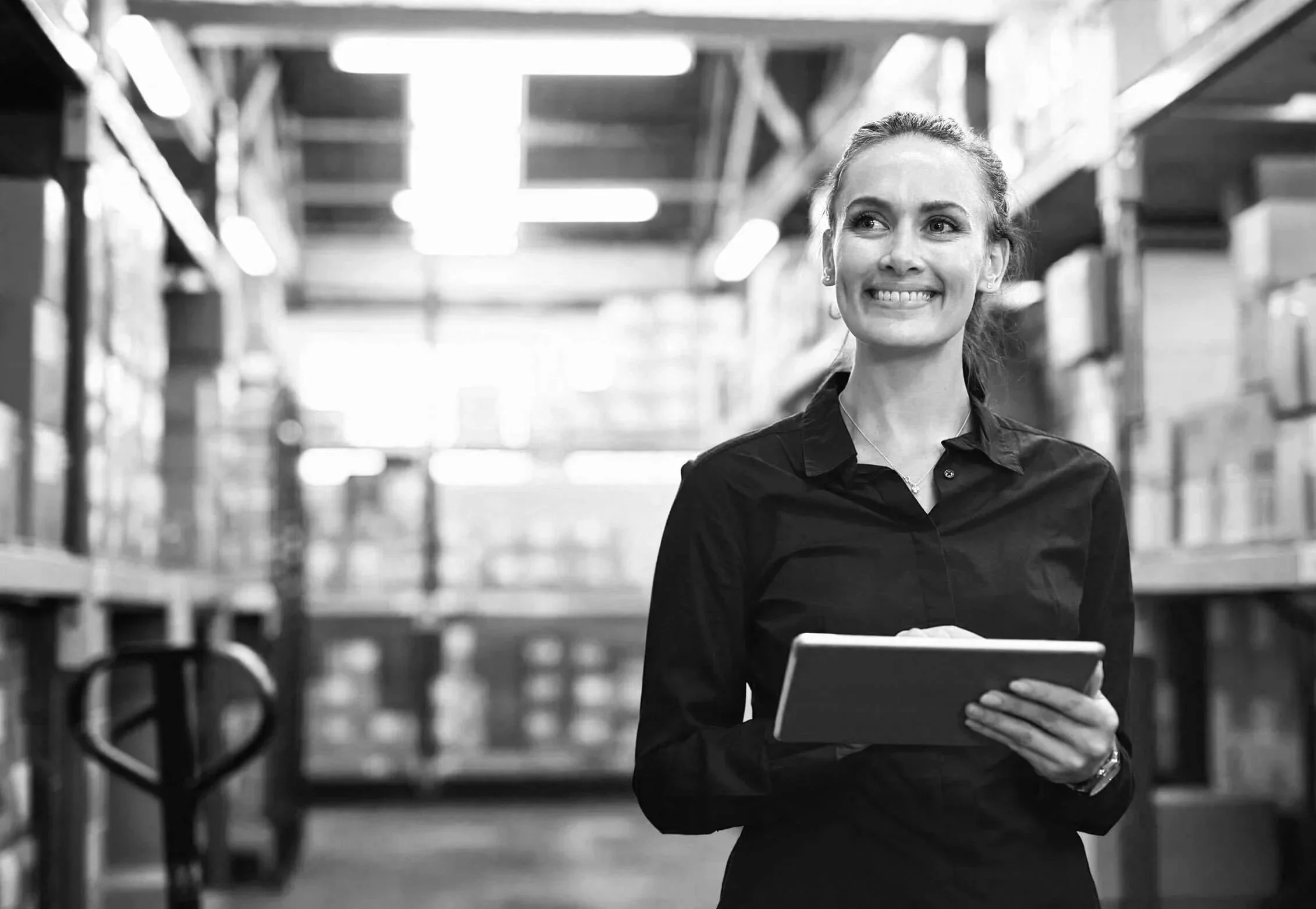 Confident female leader in warehouse setting