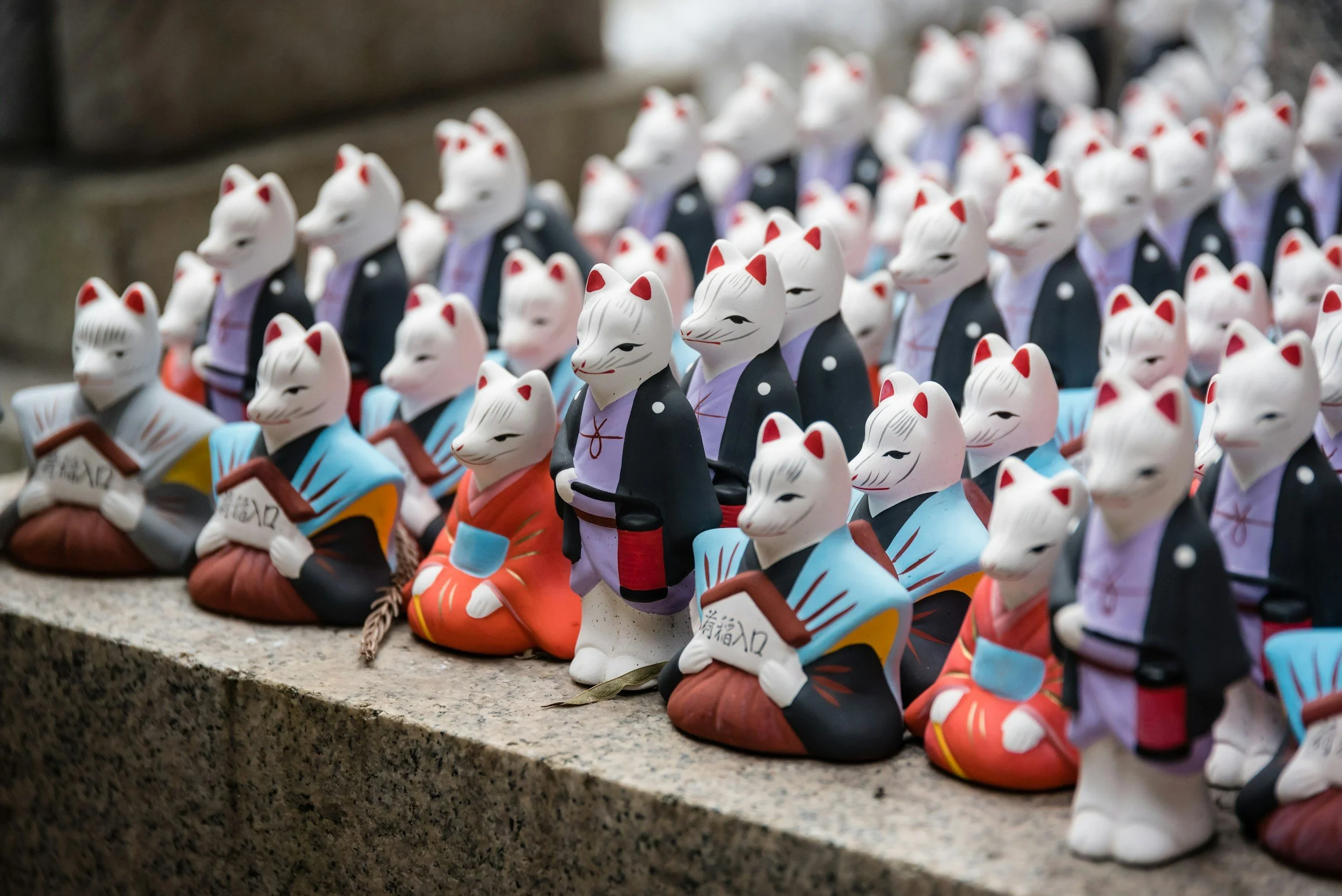 Photo of cat figurines at a Shinto shrine in Kyoto Japan.
