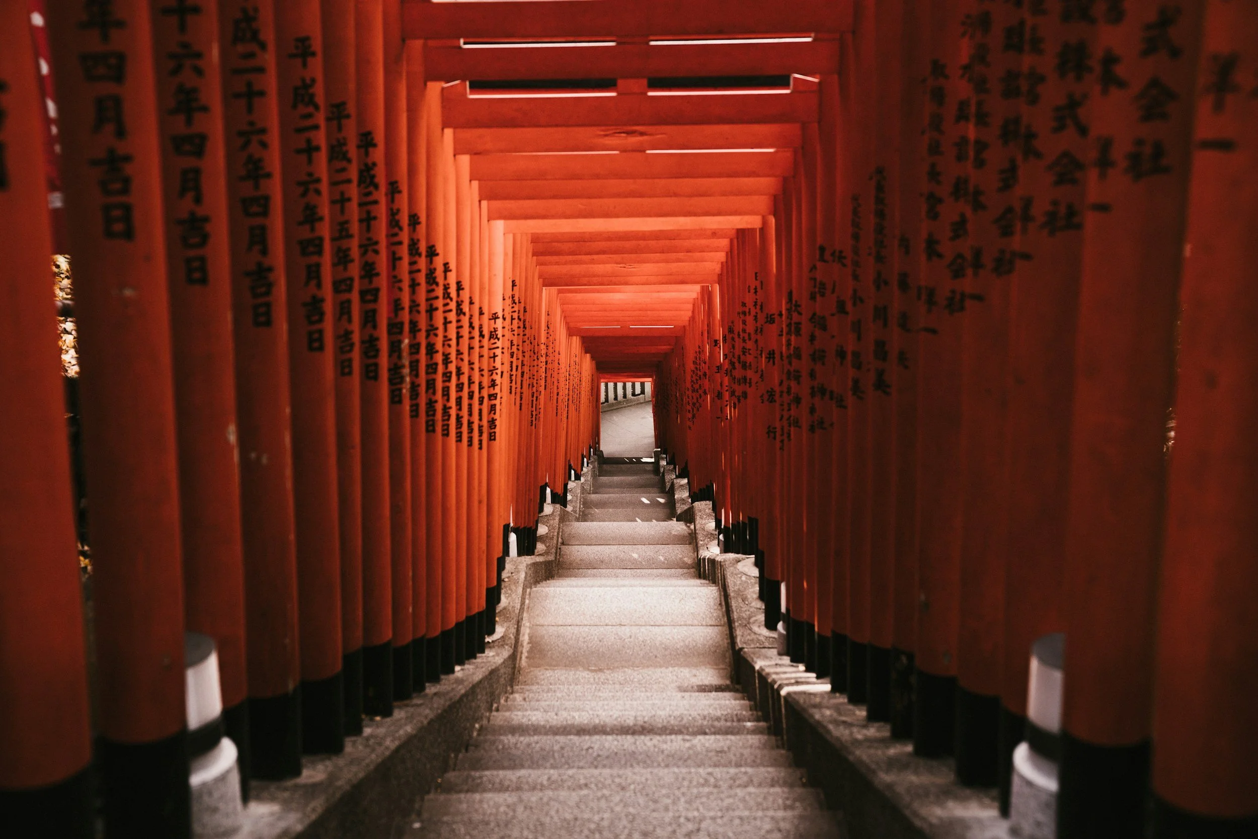 Photo of torii red gates at Fushimi Inari Taisha shrine in Kyoto Japan.