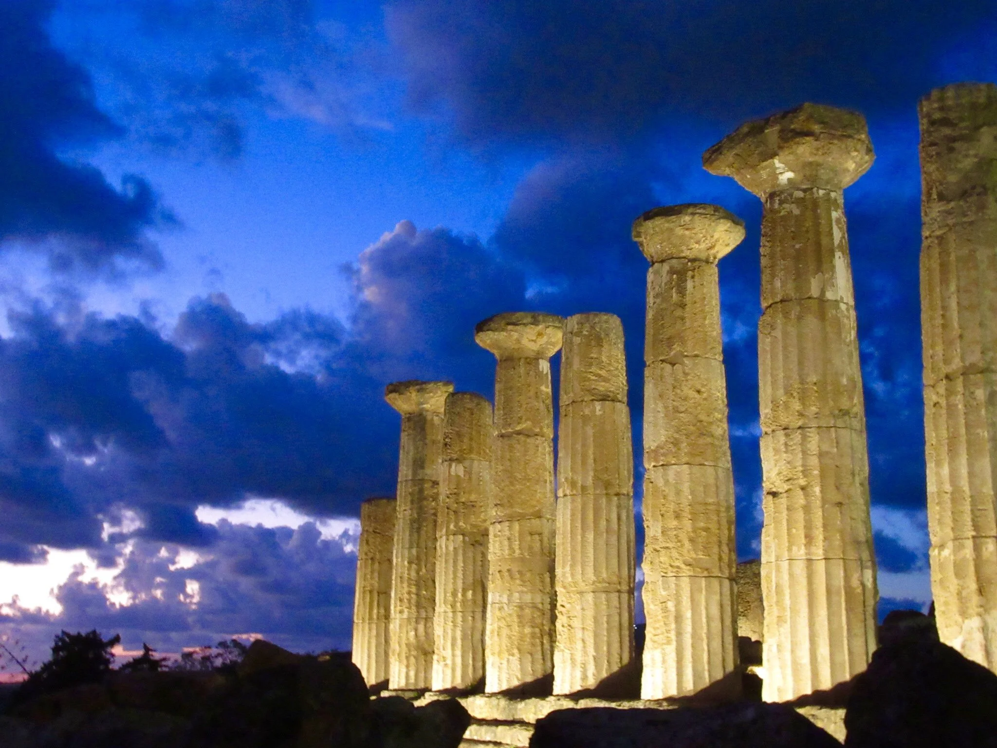 Ruins of one of the ancient Greek temples lit up at night in Agrigento, Sicily.