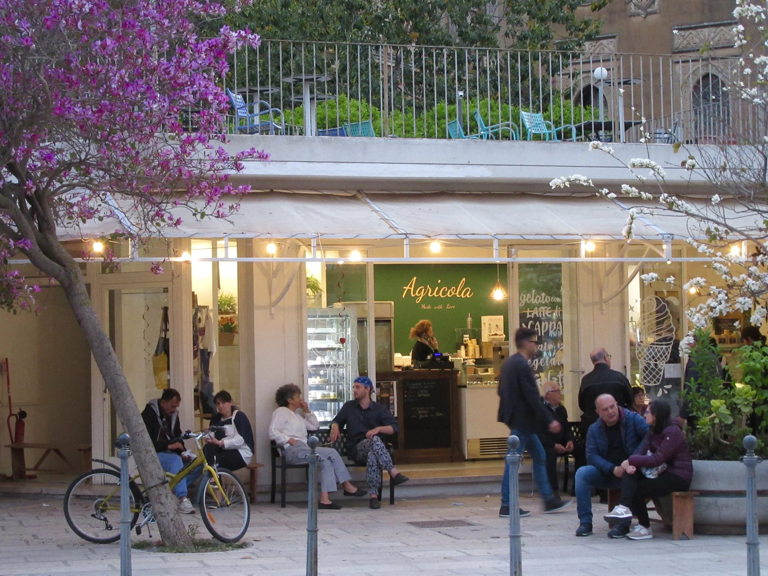People sitting outside of Agricola Gelateria in Lecce, Puglia.