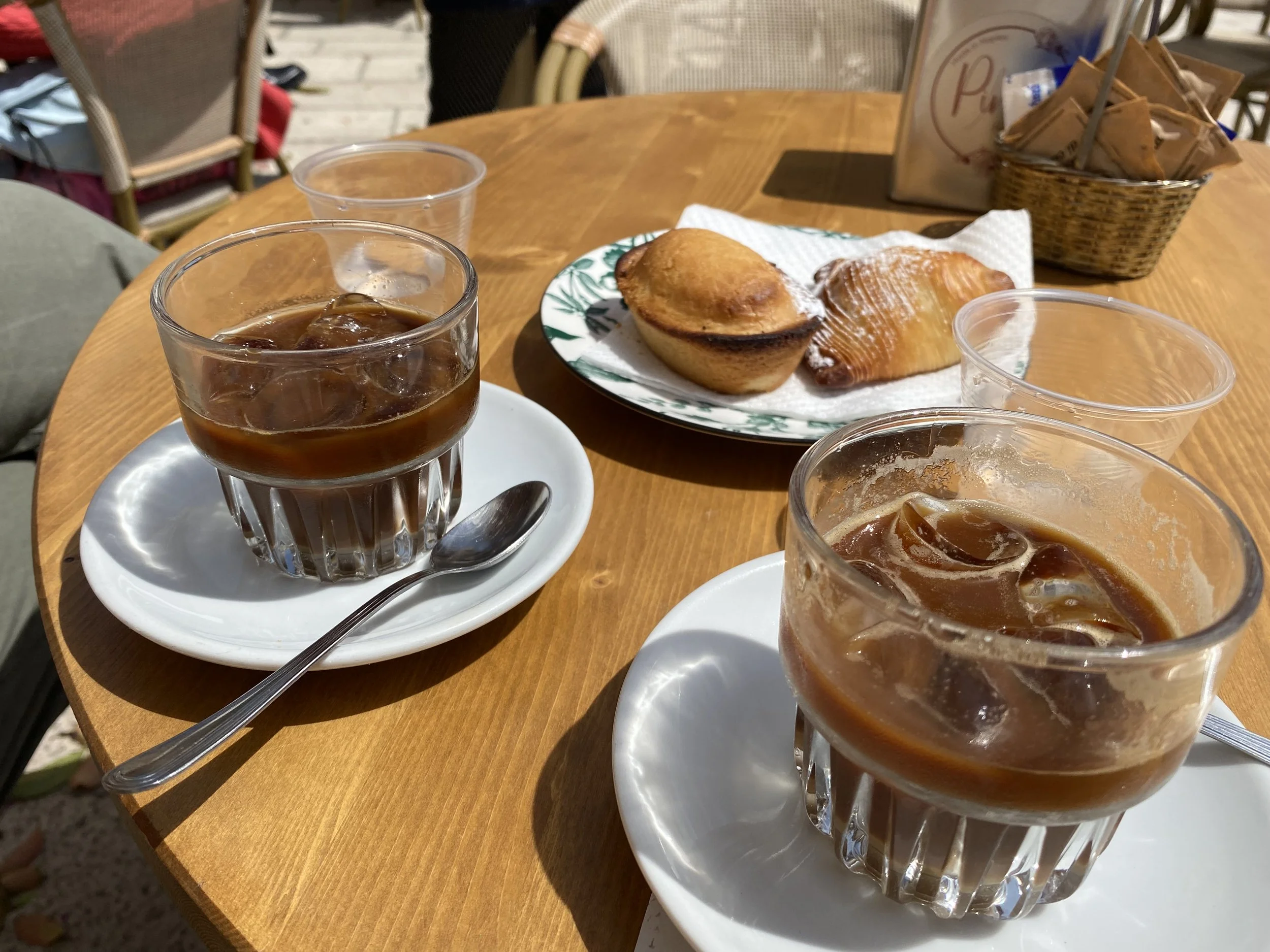 Popular iced coffees and pastries on a table in Lecce, Puglia.