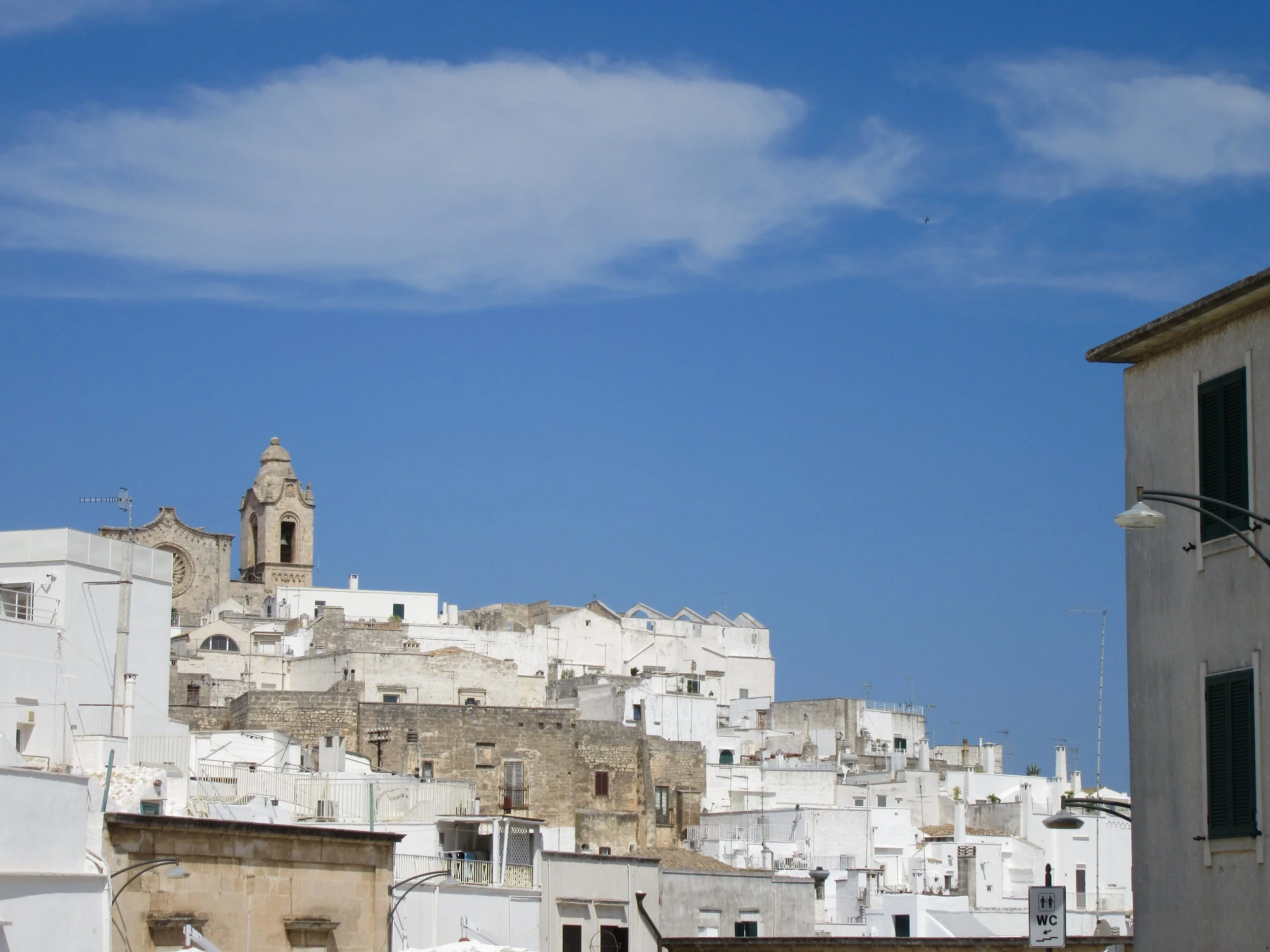 A view of Ostuni, Puglia against the background of a bright blue sky.