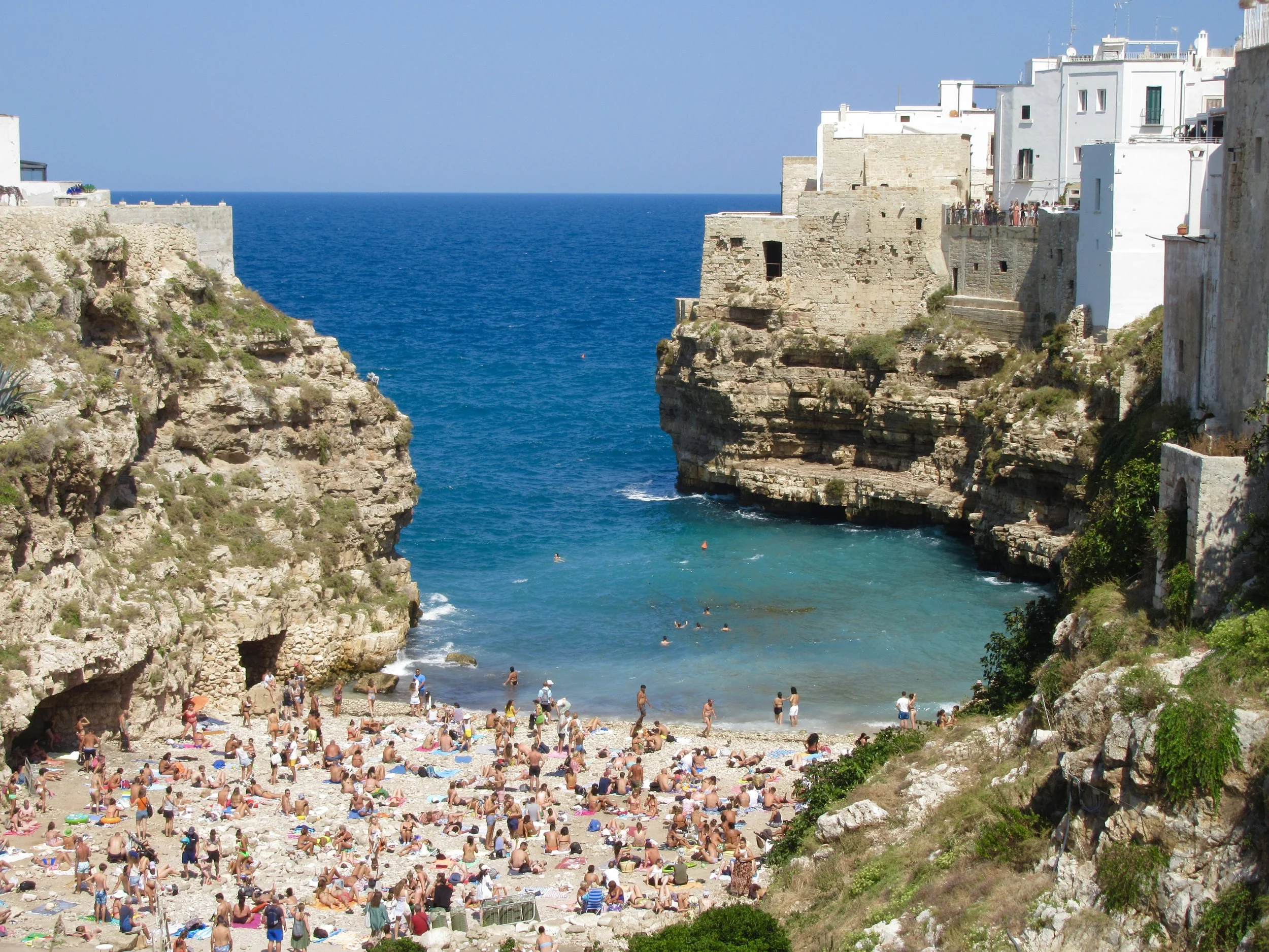 An ironic view of Lama Monachile beach in Polignano a Mare, Puglia.