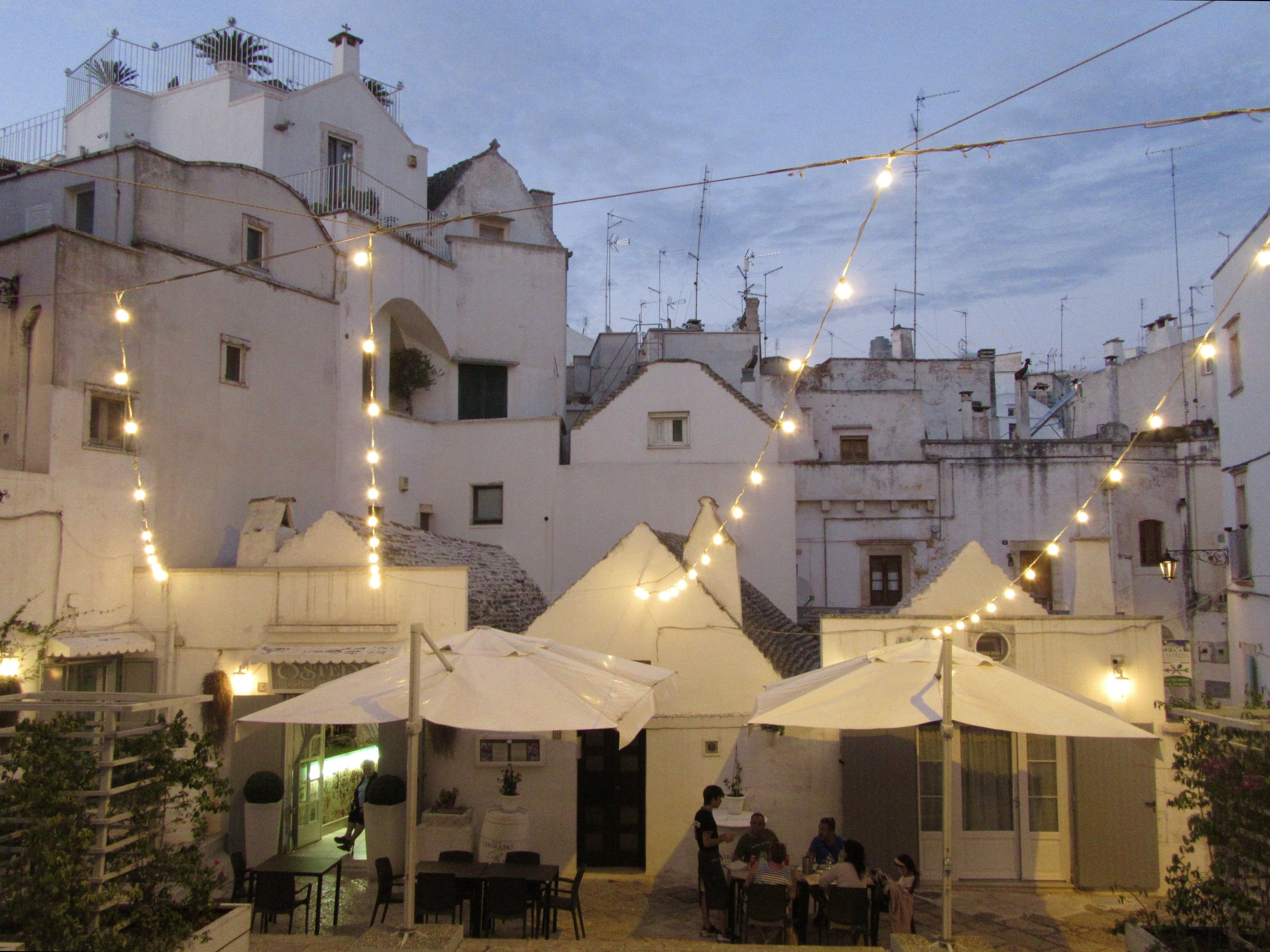 White-washed home and restaurants at dusk in Martina Franca, Puglia.