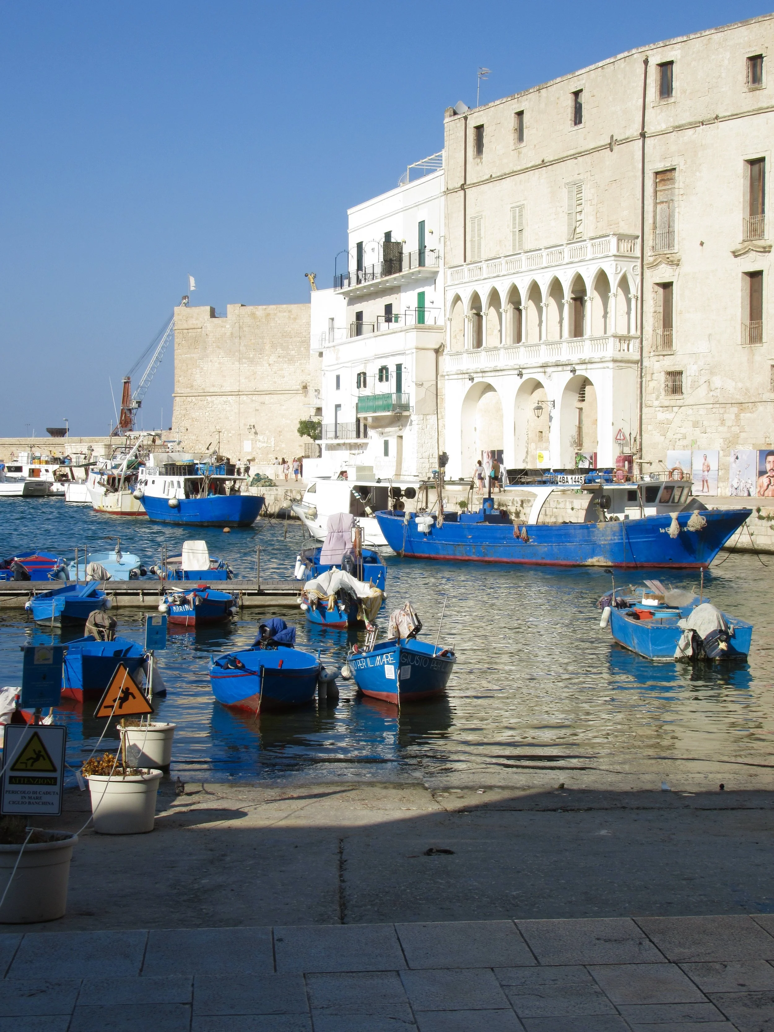 The port with blue and red fishing boats in Monopoli, Puglia.
