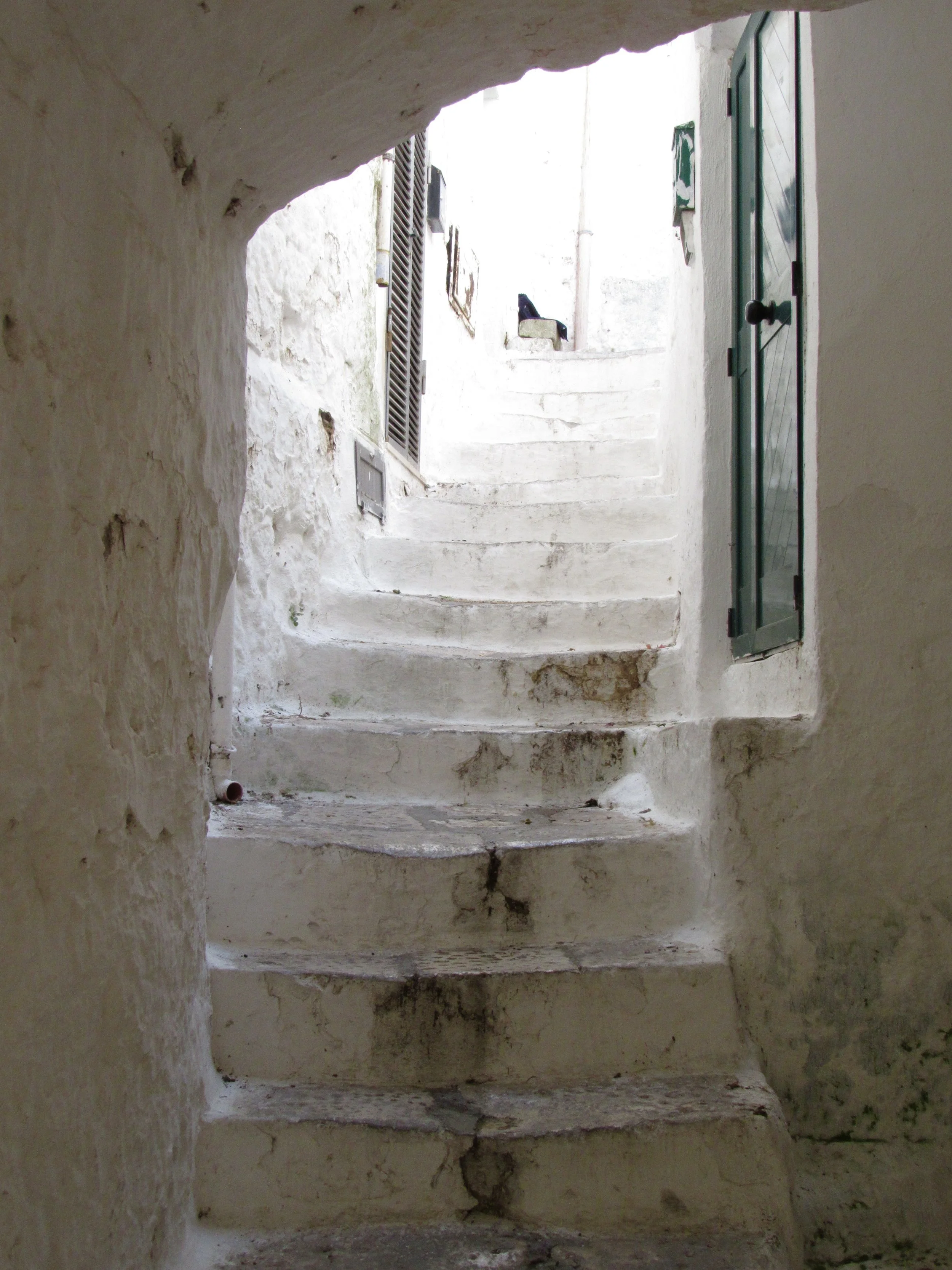 An ancient white-washed stone stairway in Ostuni, Puglia.