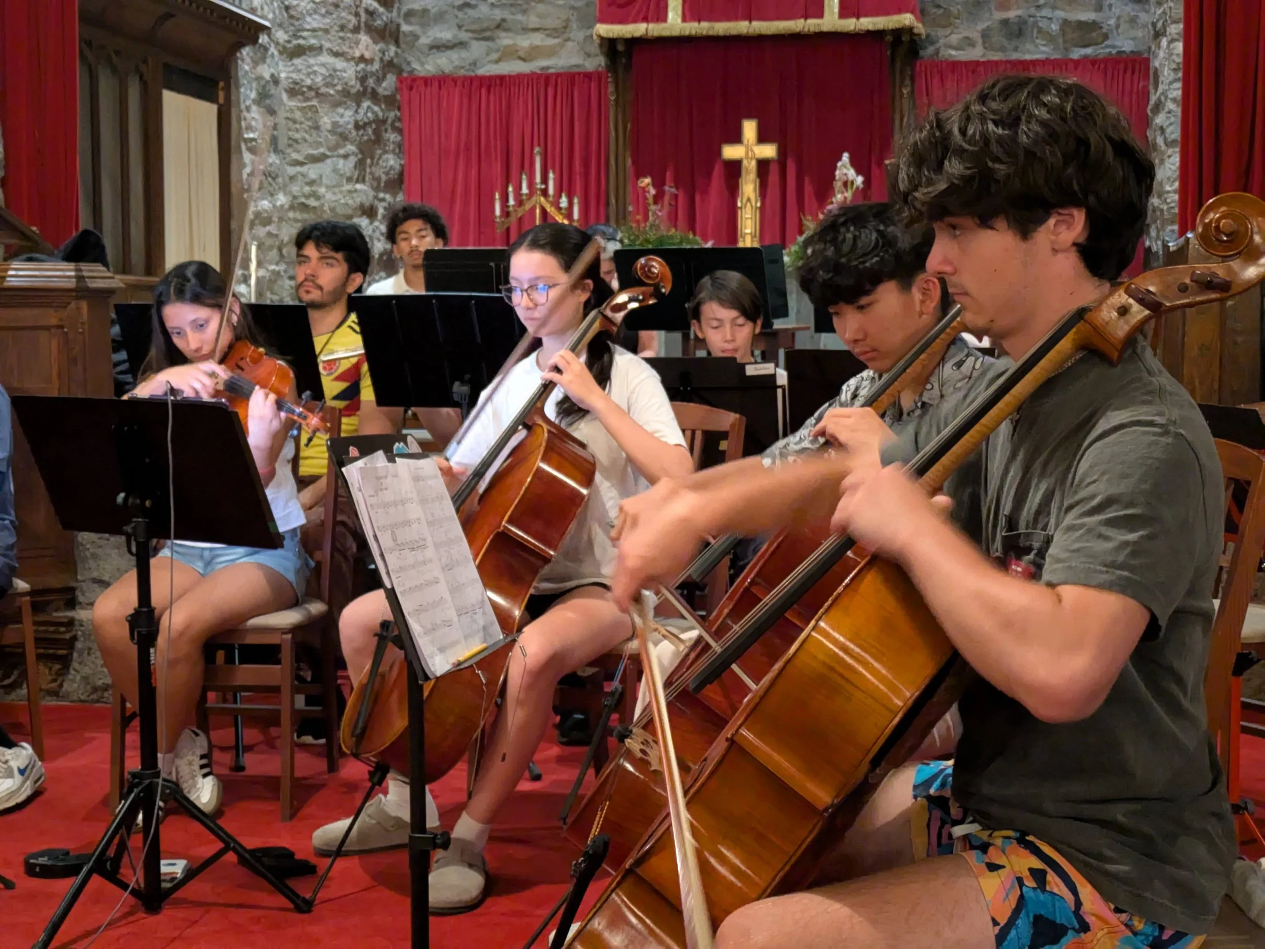 Young musicians practicing instruments with an orchestra instructor.