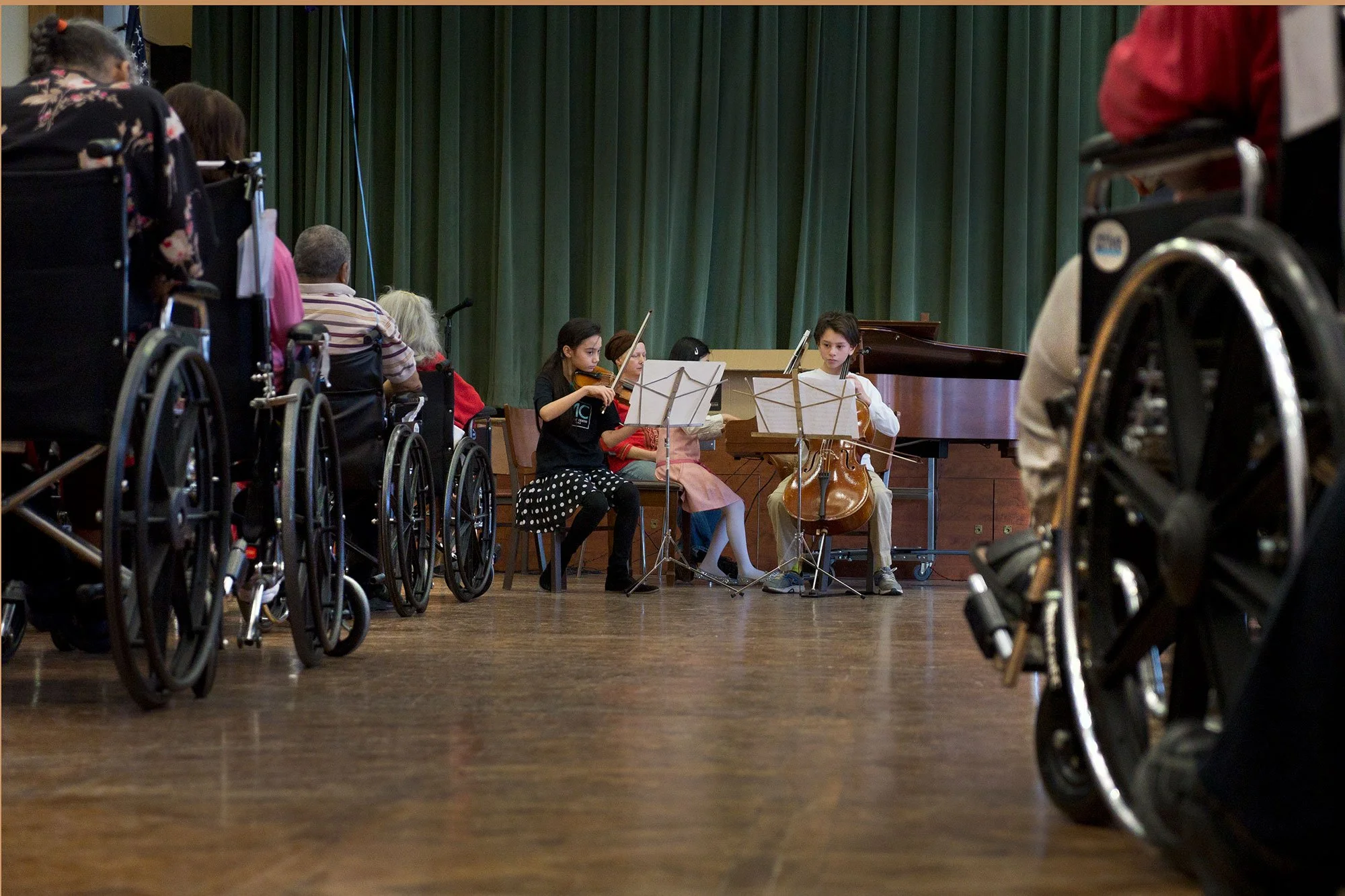 Young CMC chamber music group performing in a nursing home.
