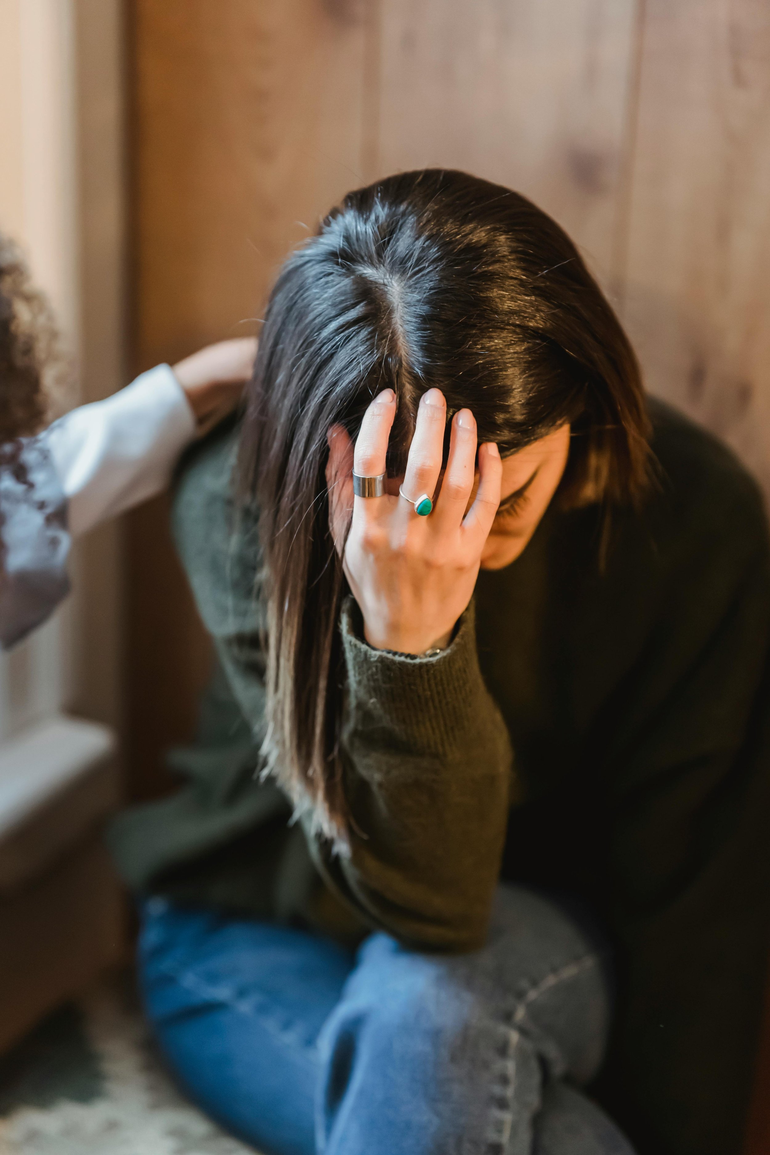 Teen with head in hands