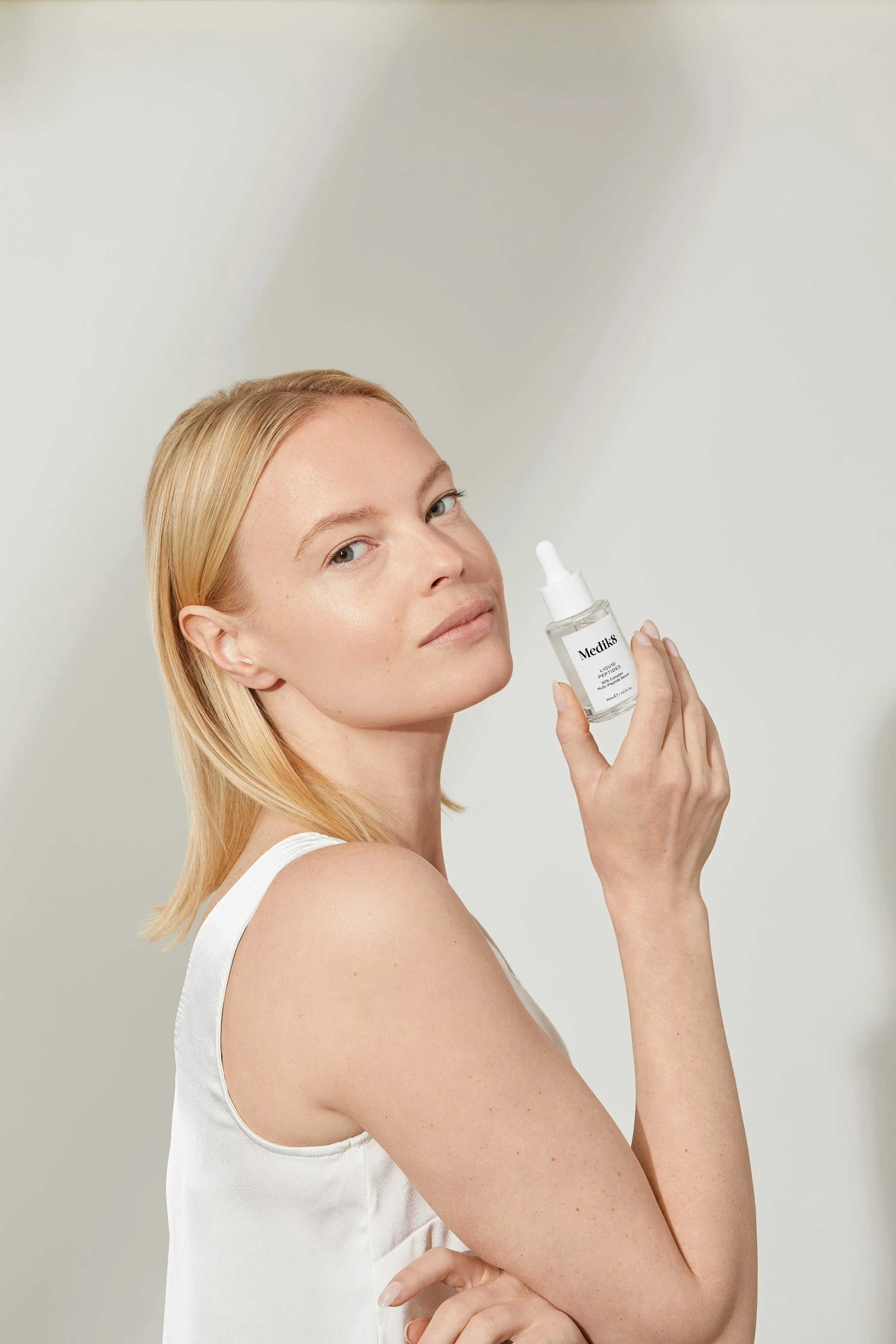 Copy%20of%2020230601%20-%20Liquid%20Peptides%20-%20Model%20Holding%20Looking%20At%20Camera%20-%20ROW%20-%20For%20Web.jpg