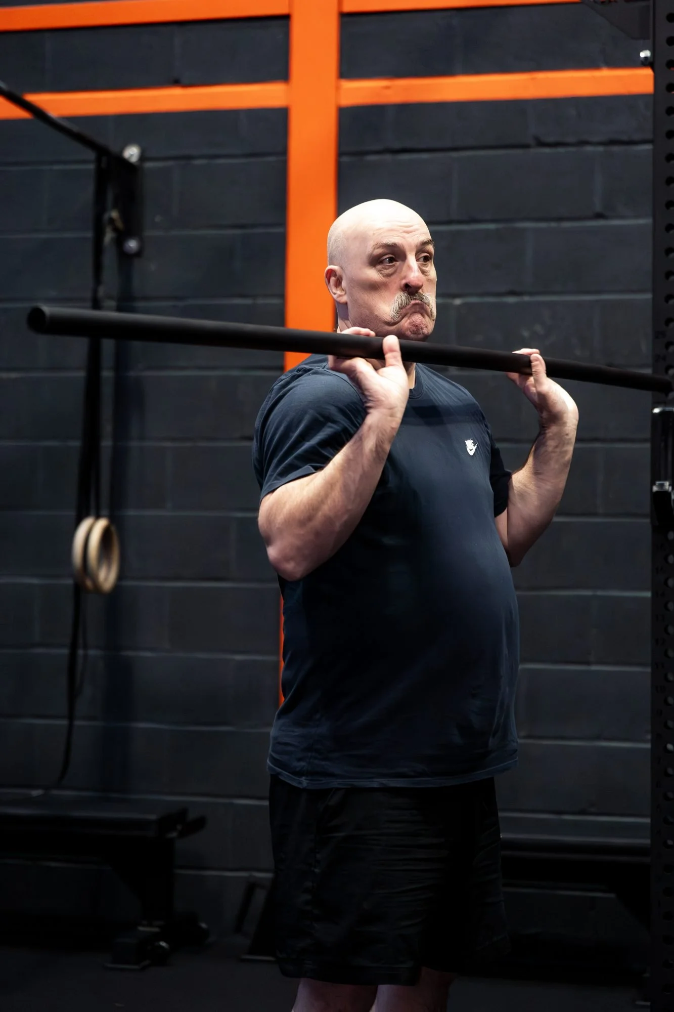 Member practising a front squat with a training bar at CrossFit Ex Terra