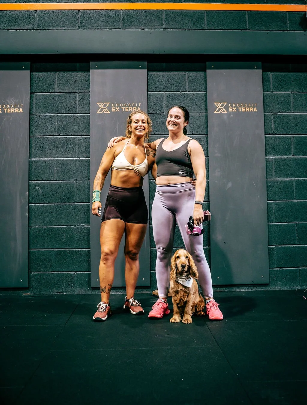 Two members with a dog inside CrossFit Ex Terra gym, St Helens