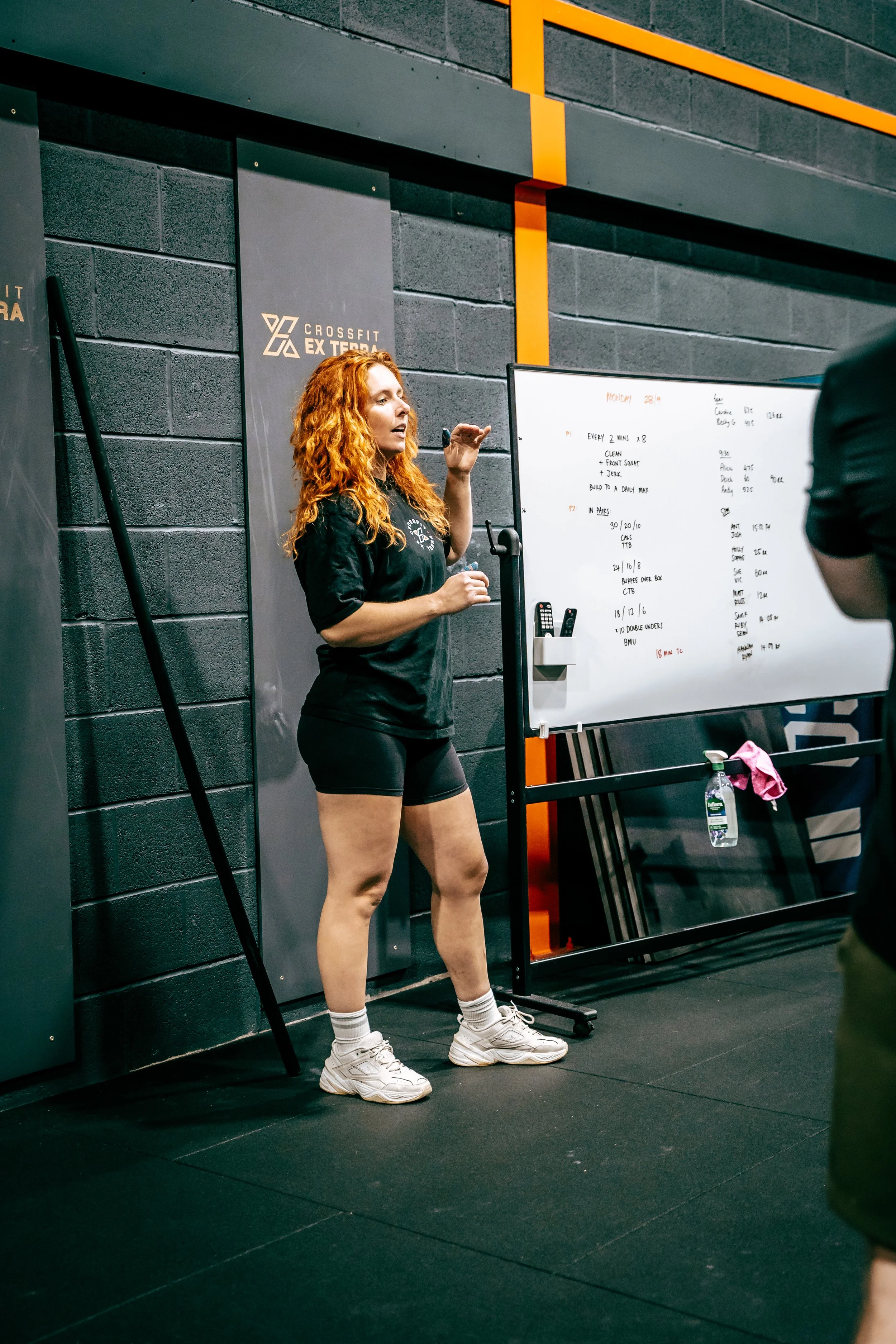 Woman by the whiteboard during a class at CrossFit Ex Terra