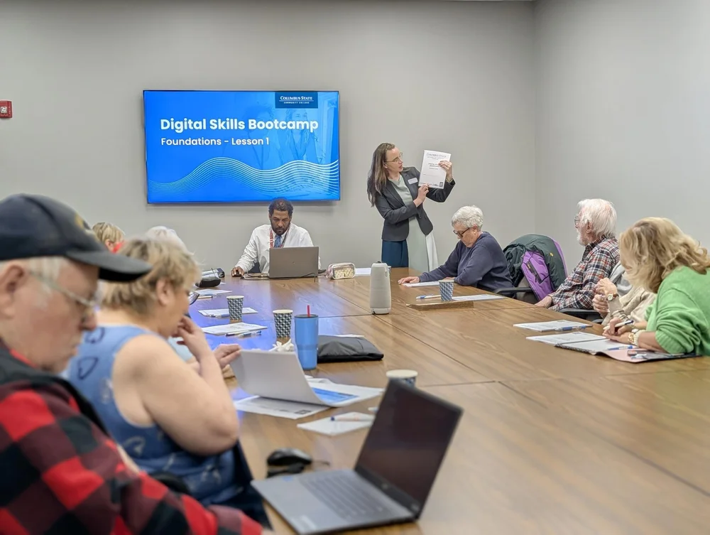 An older adult receiving help with digital technology
