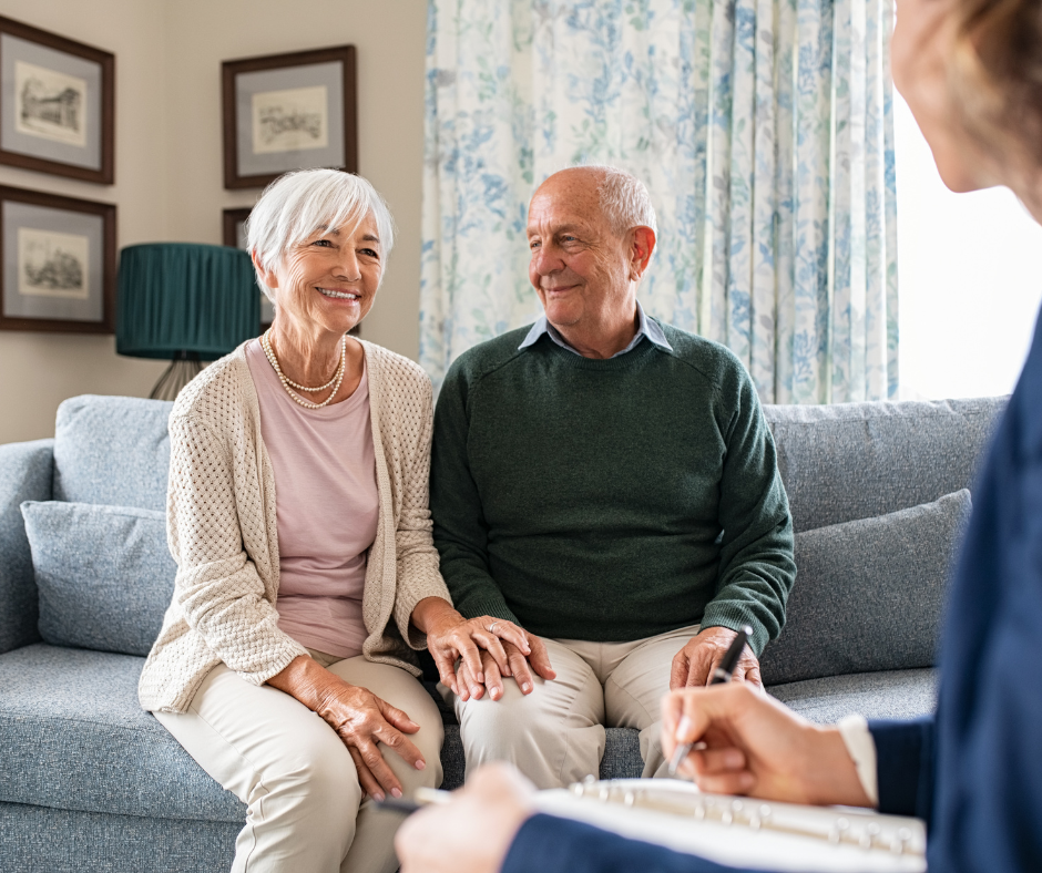 An older couple talking with a support professional