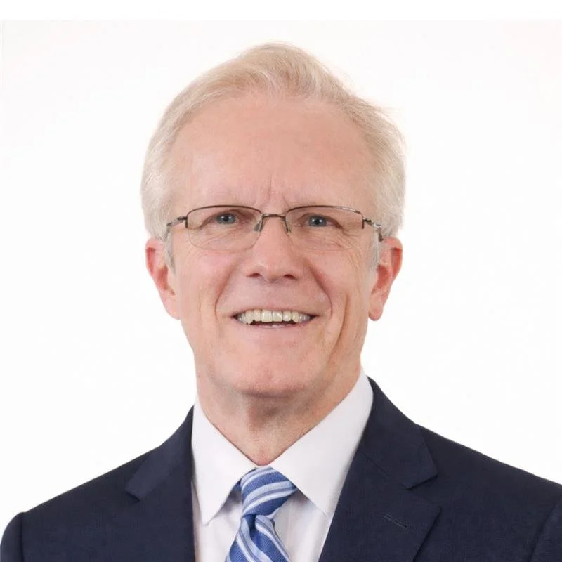 Elderly man in a suit and tie with a neutral expression