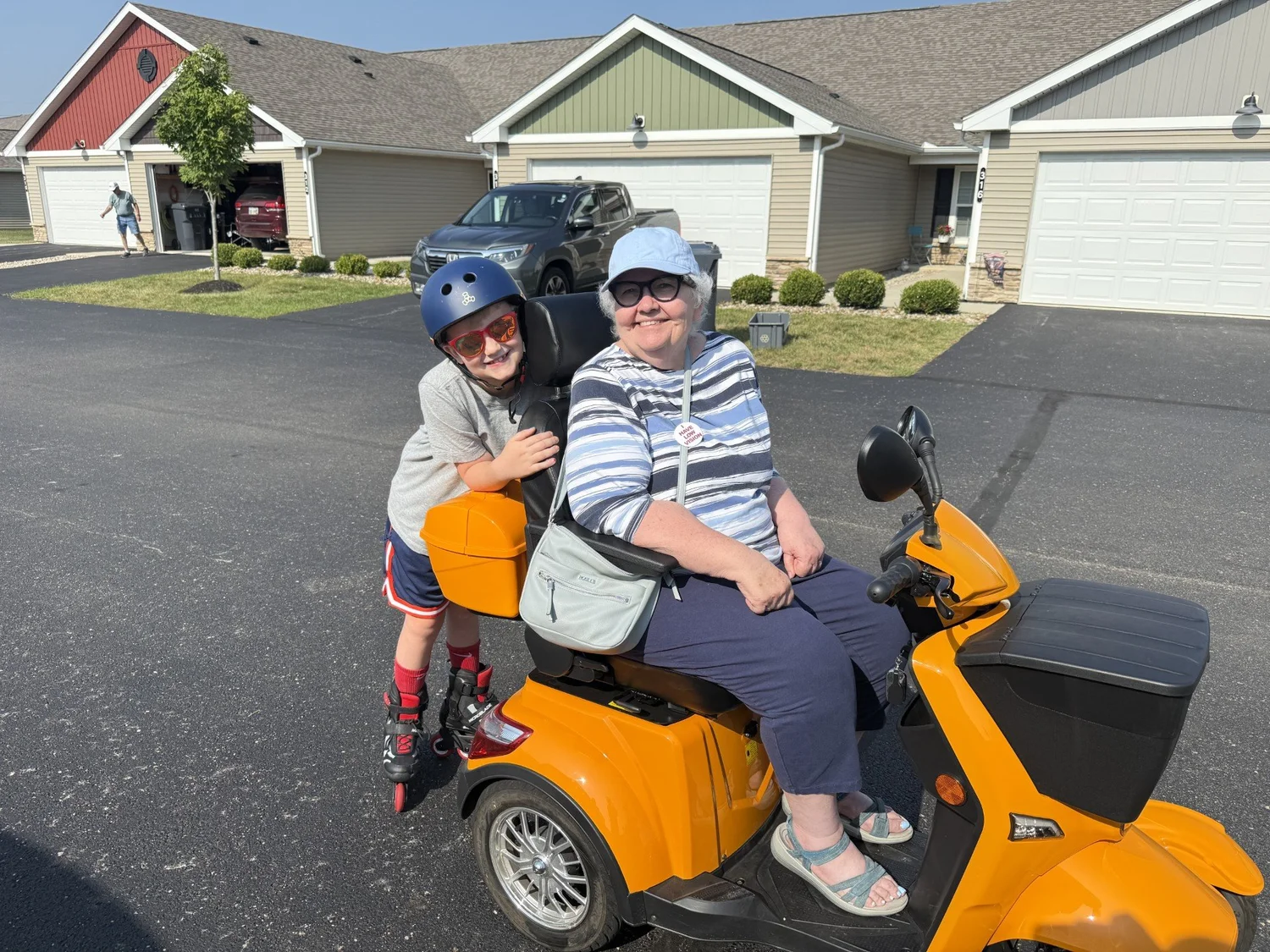 An older adult and child smiling together outdoors