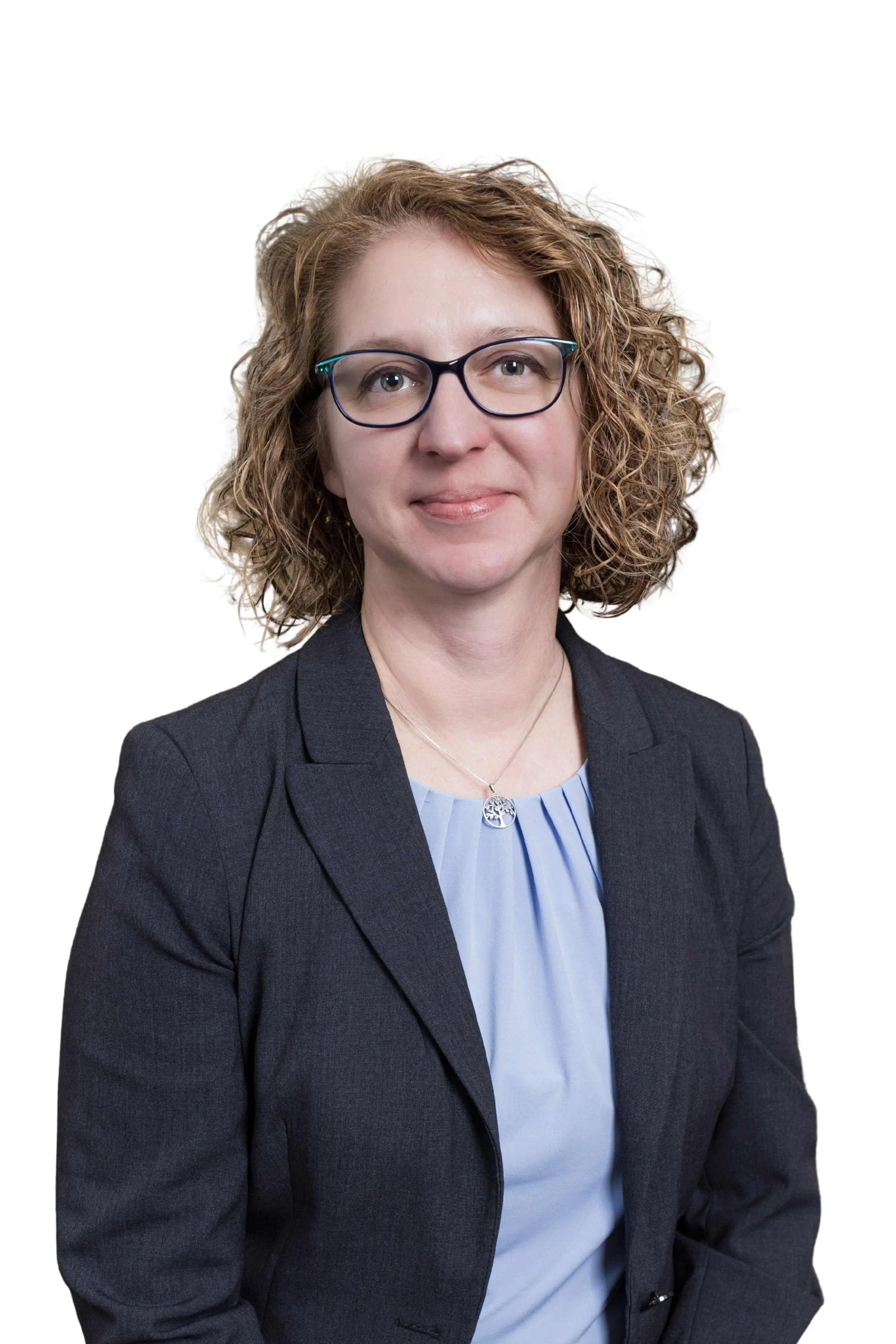 Person with long blonde hair smiling, wearing a white top and necklace.