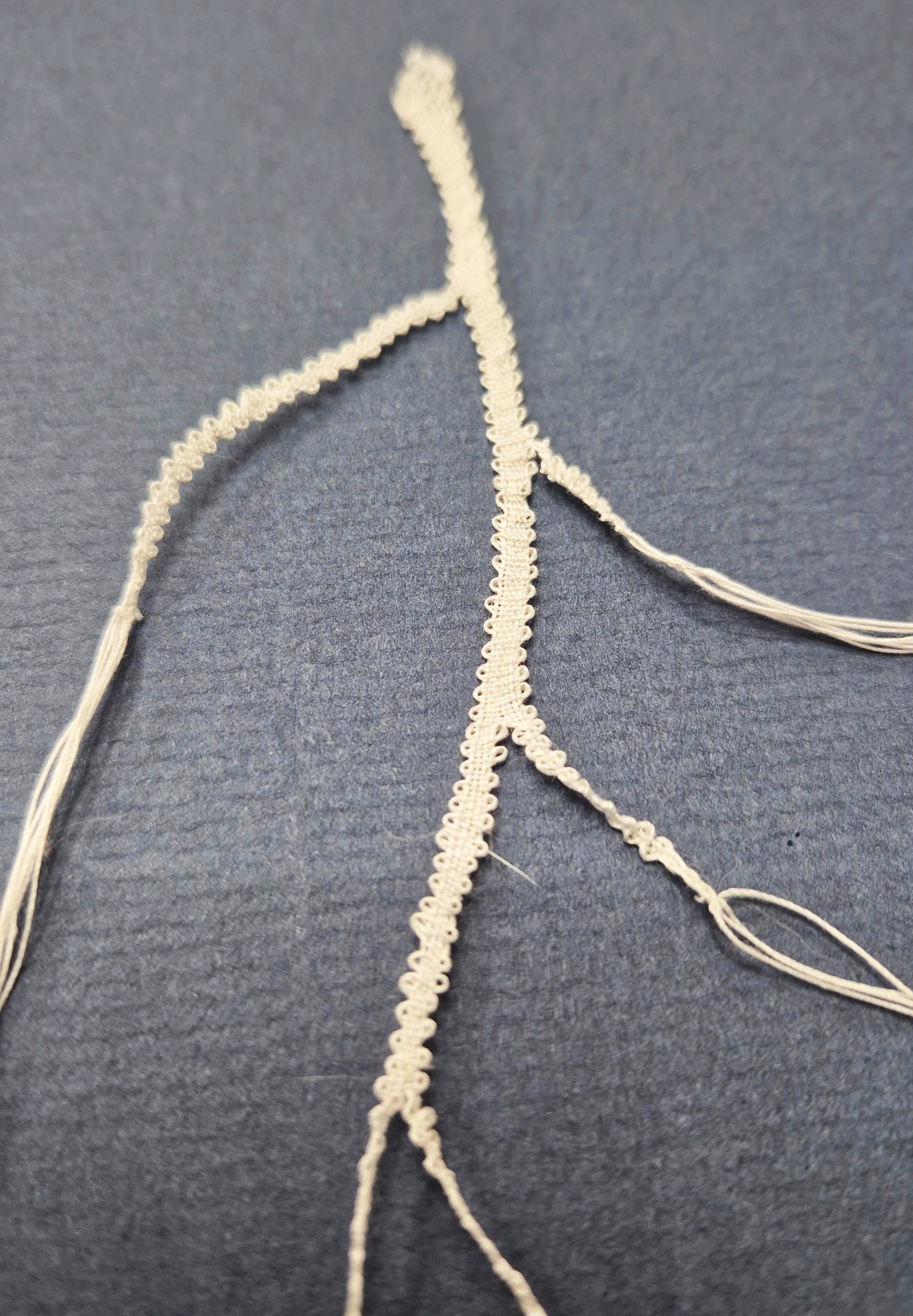 Bobbin lace freeform piece mirroring a strand of mycelium