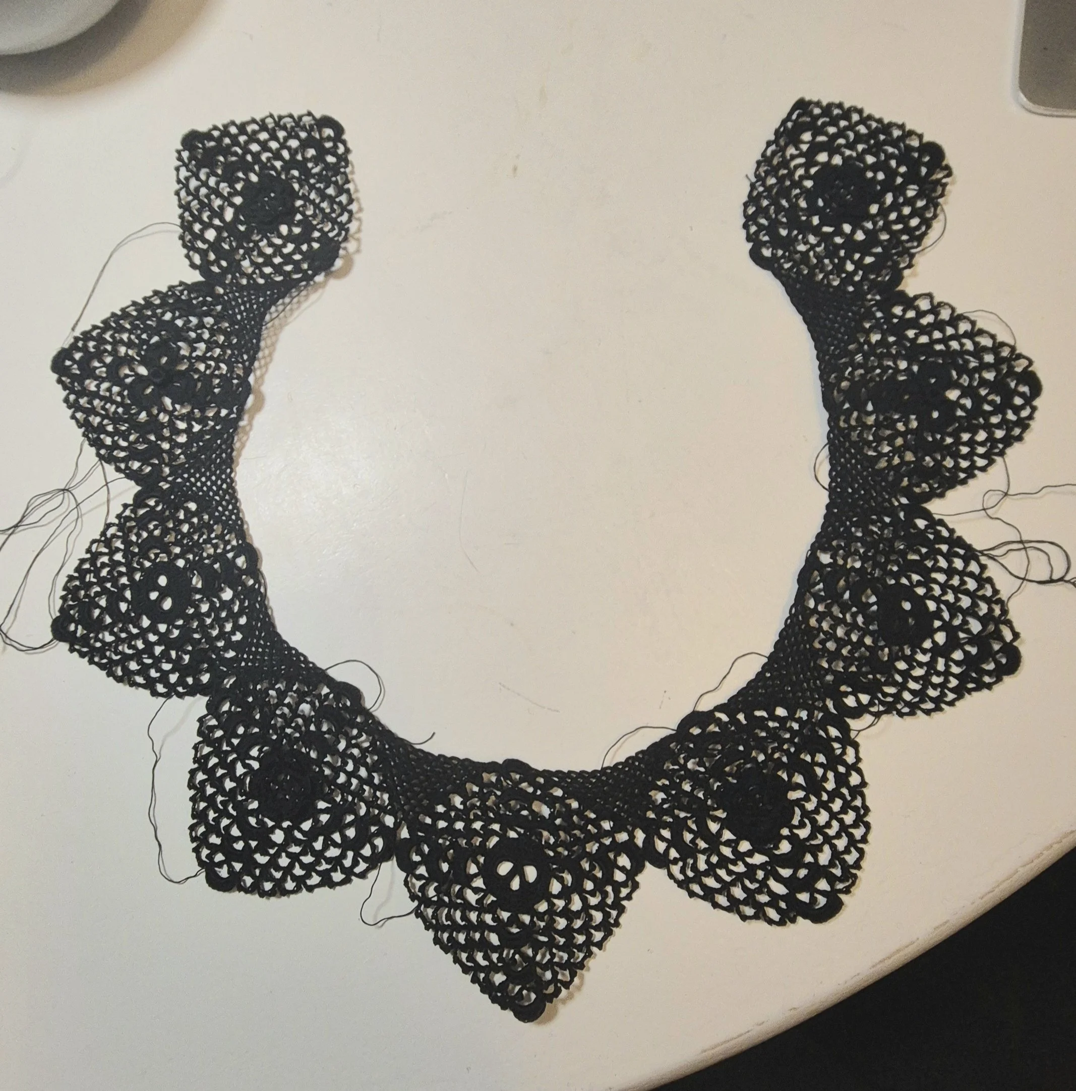 This work-in-progress collar, based on a traditional Clones Irish crochet lace design by Máire Treanor features motifs of shamrocks, roses and skulls - revisiting the themes of rebirth, heritage and Irish flora I've explored throughout this project. 