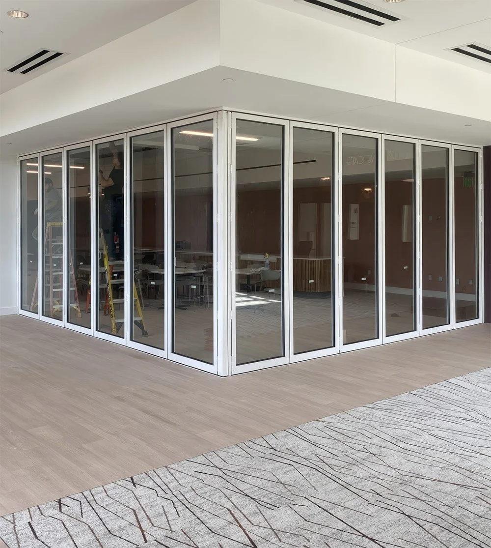 White Corner Bi-Fold Door System for a College Campus