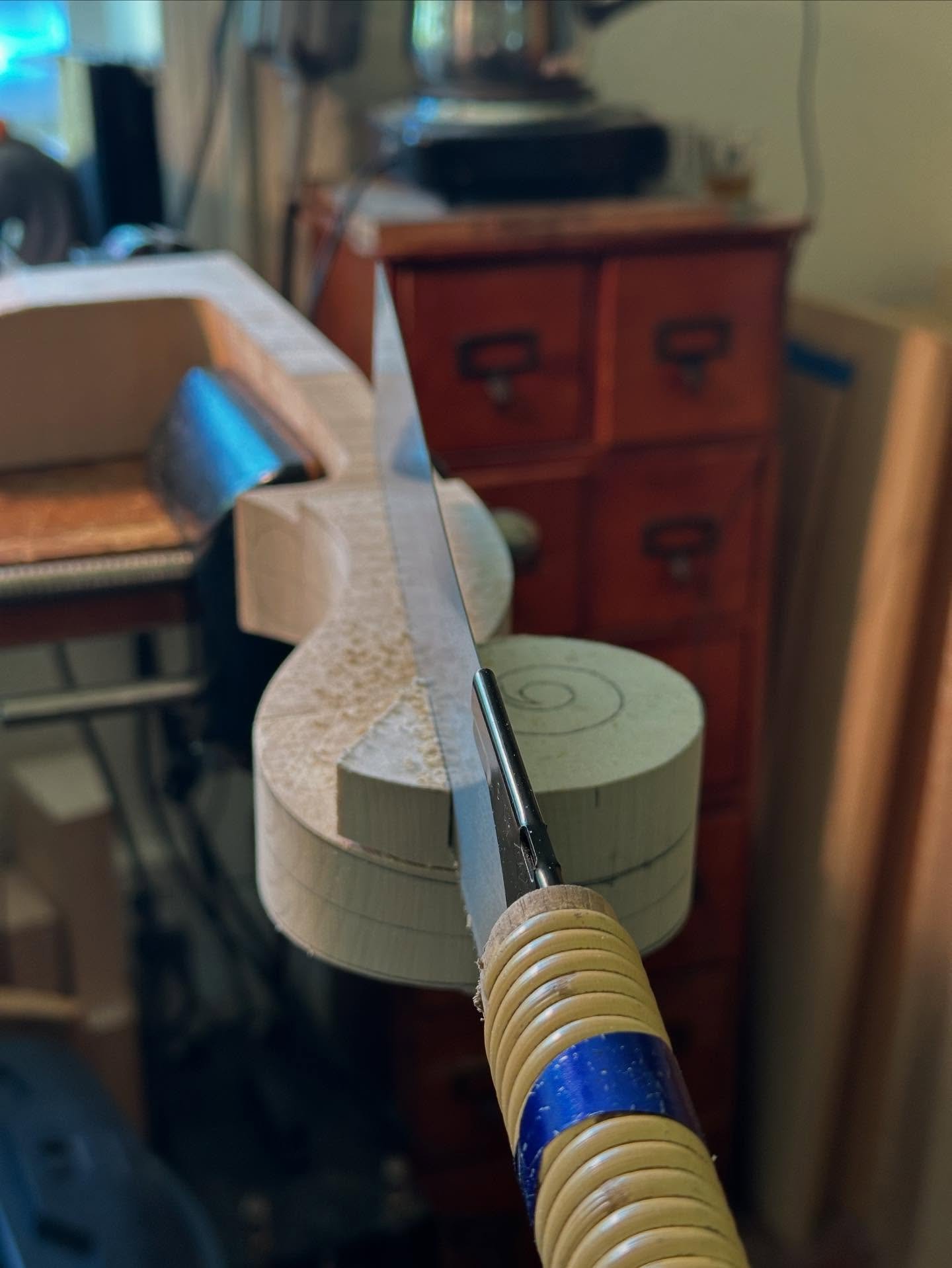 Sawing out the turns of a cello scroll