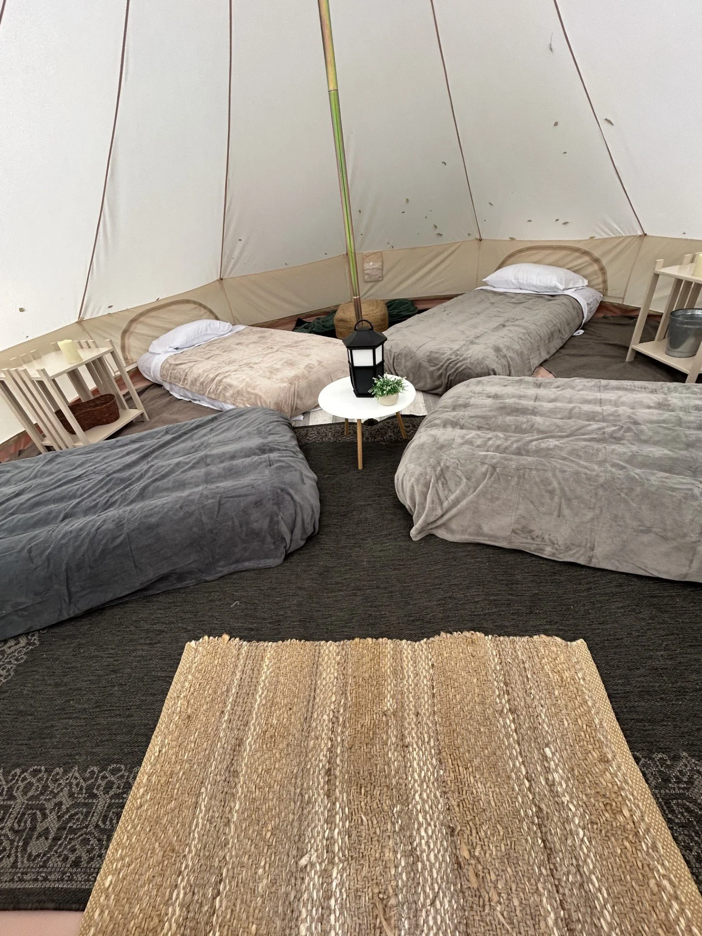 Multiple twin mattress setup inside a glamping tent styled for a boys birthday party in Roanoke, VA