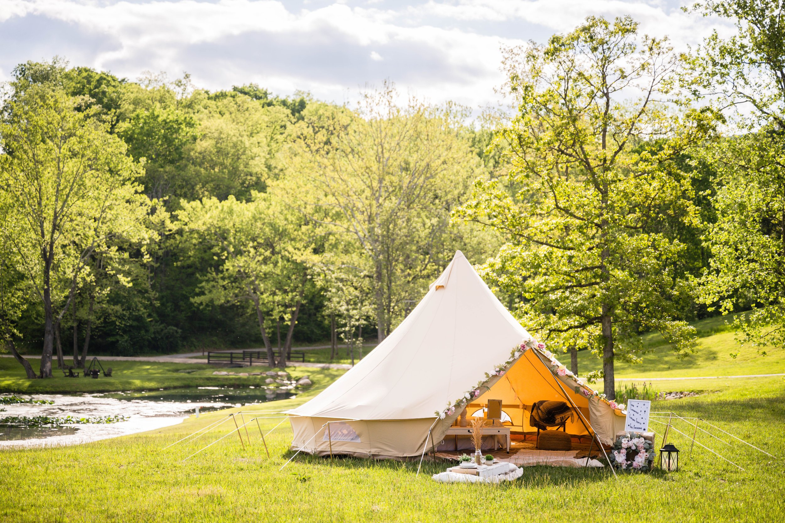 Mobile wedding glamping tent reception setup in Salem, VA with elegant décor and a fully furnished bell tent by Star City Glamping