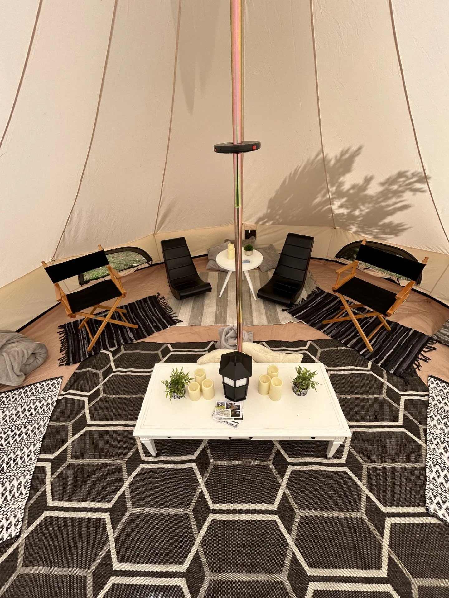 Luxury mobile glamping lounge setup in Salem, VA featuring a fully furnished bell tent with cozy seating and soft lighting