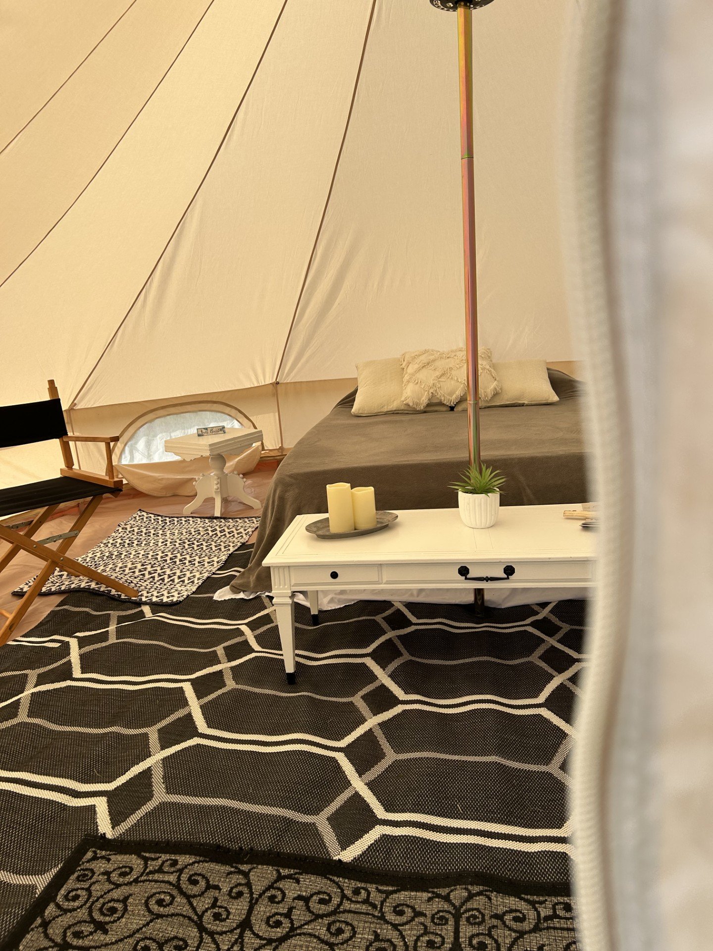 Interior of a luxury glamping tent with a queen bed set up in Roanoke, VA