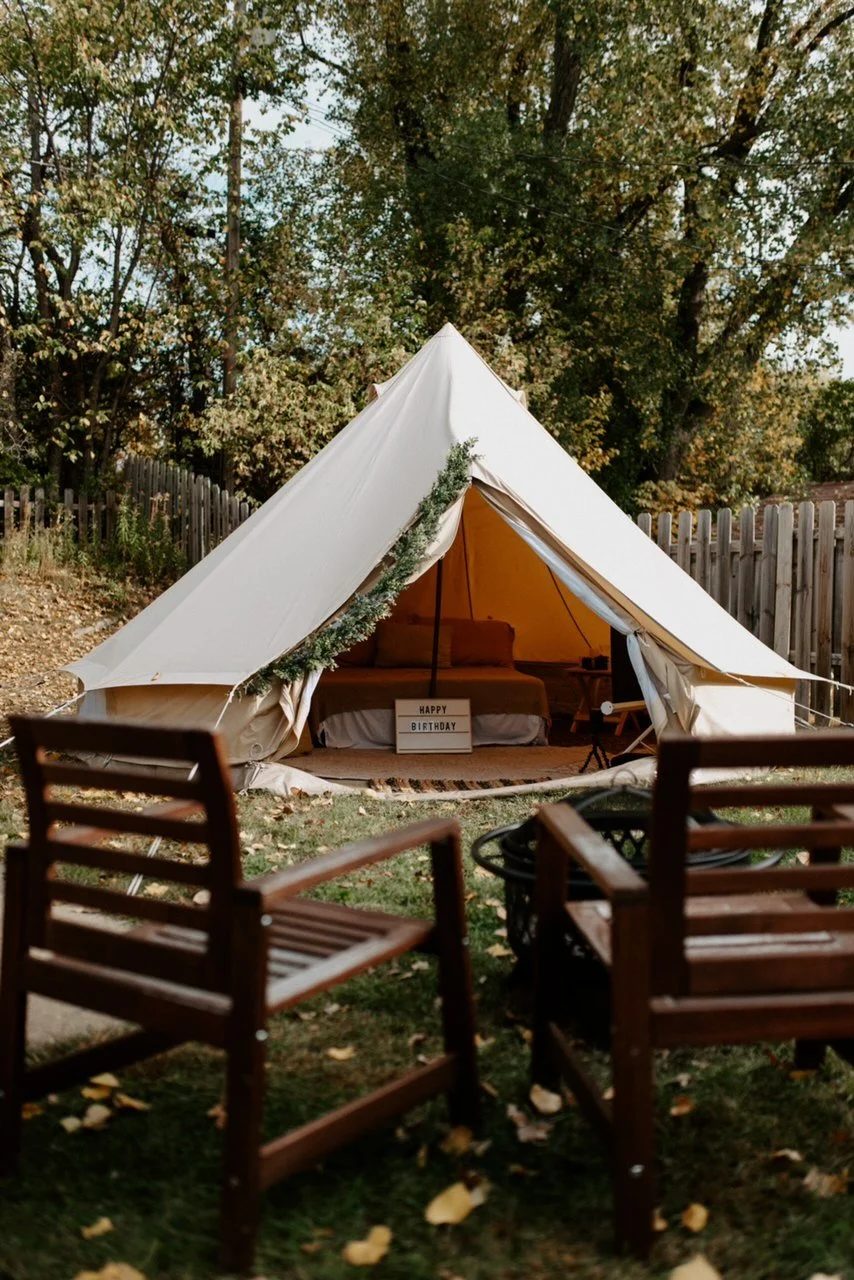 Luxury backyard glamping tent interior with styled décor and bedding in Roanoke, VA