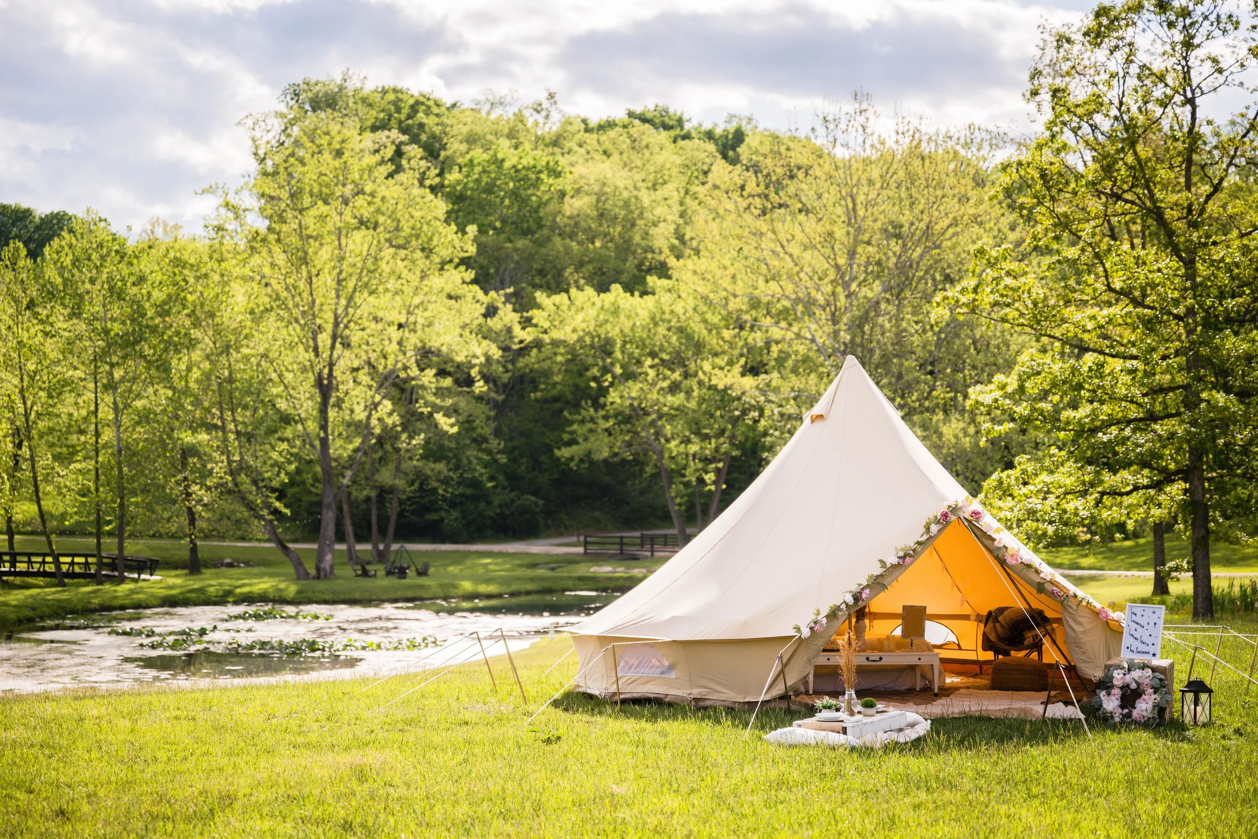 Luxury wedding glamping tent setup at Smith Mountain Lake & Bedford, VA with cozy interior and string lights