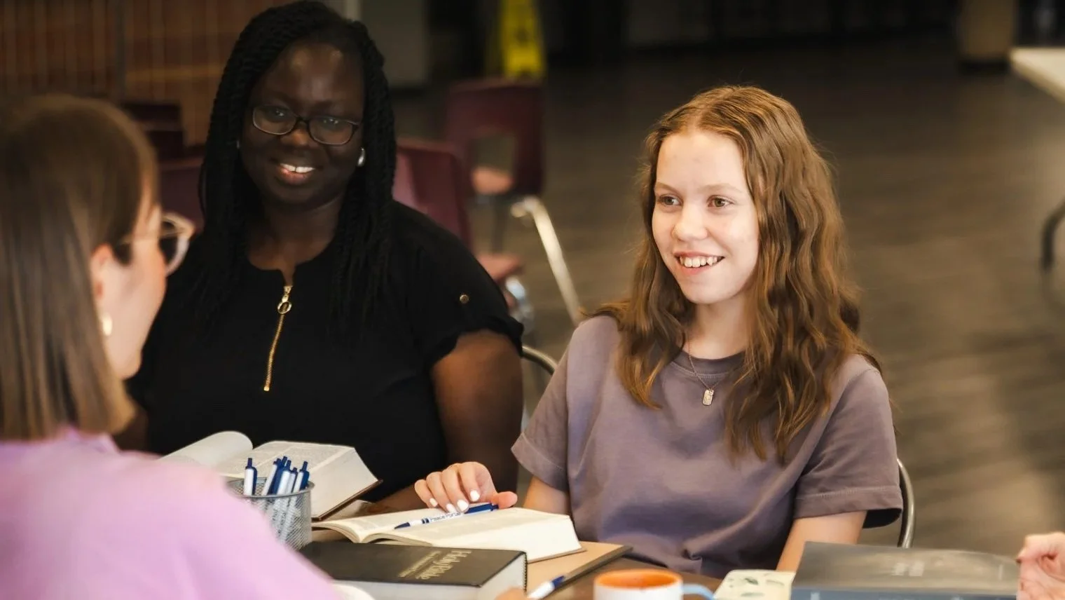 Women around a table smiling