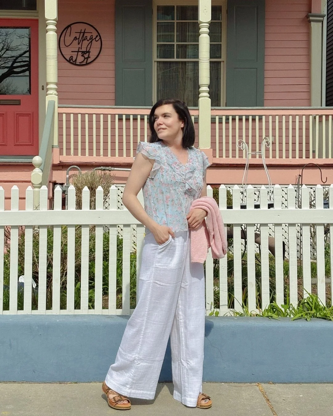 Time to wake among the cutest cottages in Cape May, wearing your most spring-ready outfit!

Sabrina&rsquo;s choice today:

White pants: Vineyard Vines
Ruffle shirt: Flag &amp; Anthem
Sandals: L&rsquo;artiste
Pink sweater: Avalin
West Coast Sunglasses