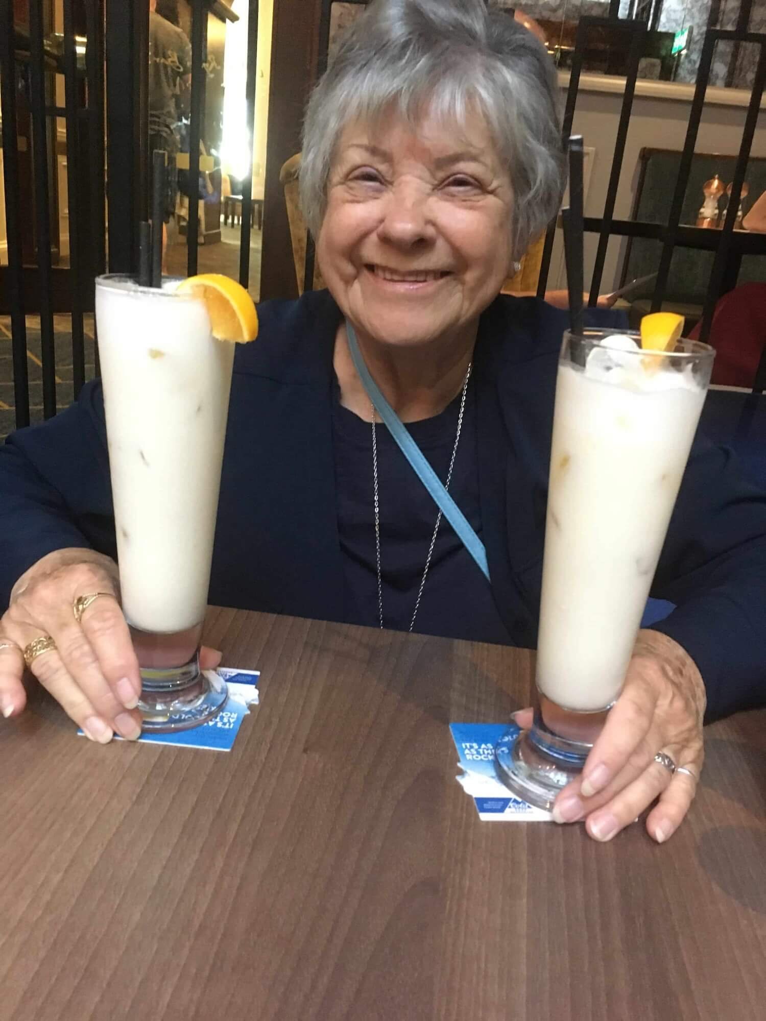 A woman with two drinks at an Irish Pub