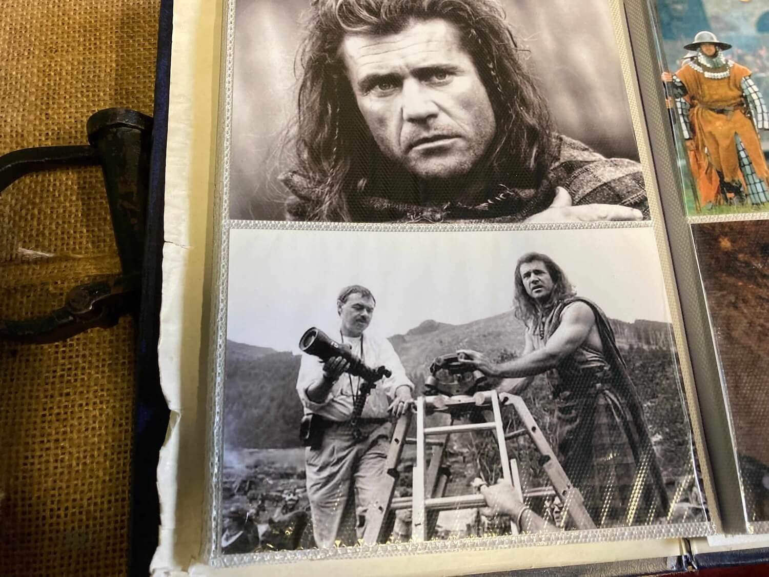 a photo album displaying photos of Mel Gibson with a photographer on the Braveheart set