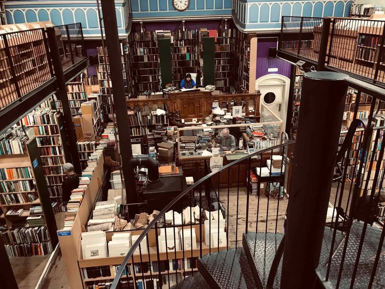 from the second story of Leakey's Bookshop there are stacks of books and wooden desks