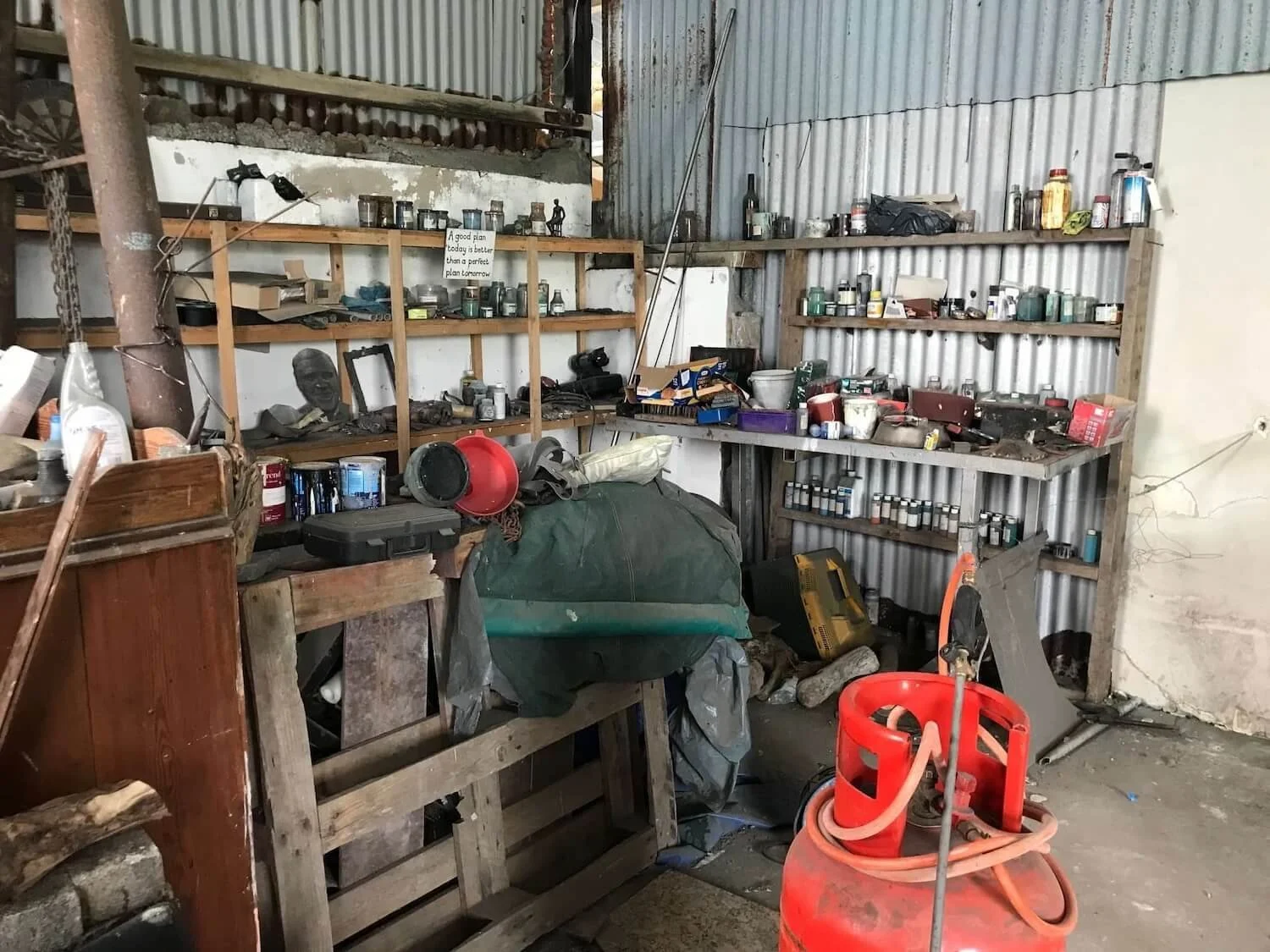 shelves of sculpting tools and supplies in an artist's workshop