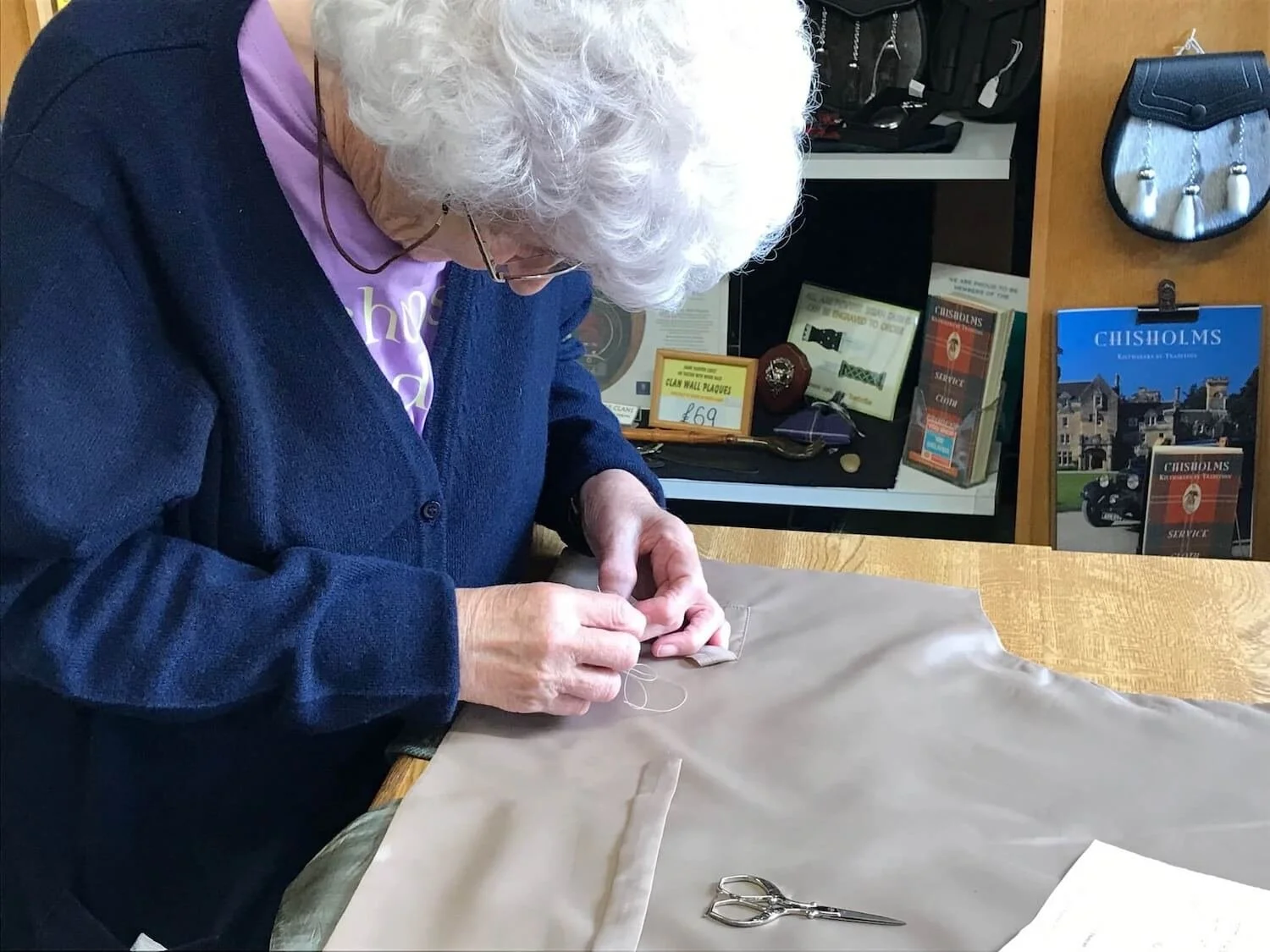 Scottish women hand sewing fabric for a quilt