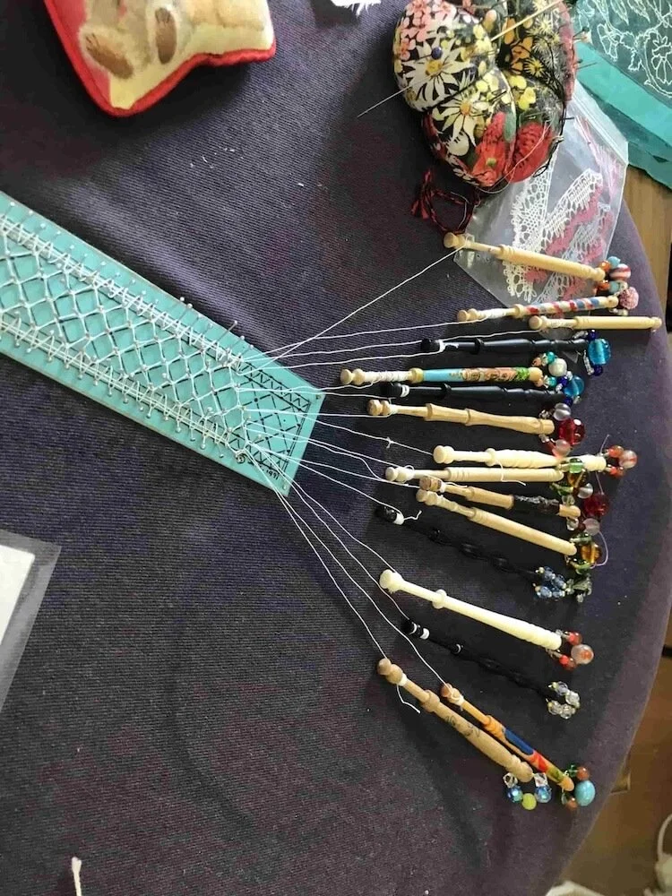 Lace bobbins lying on a table